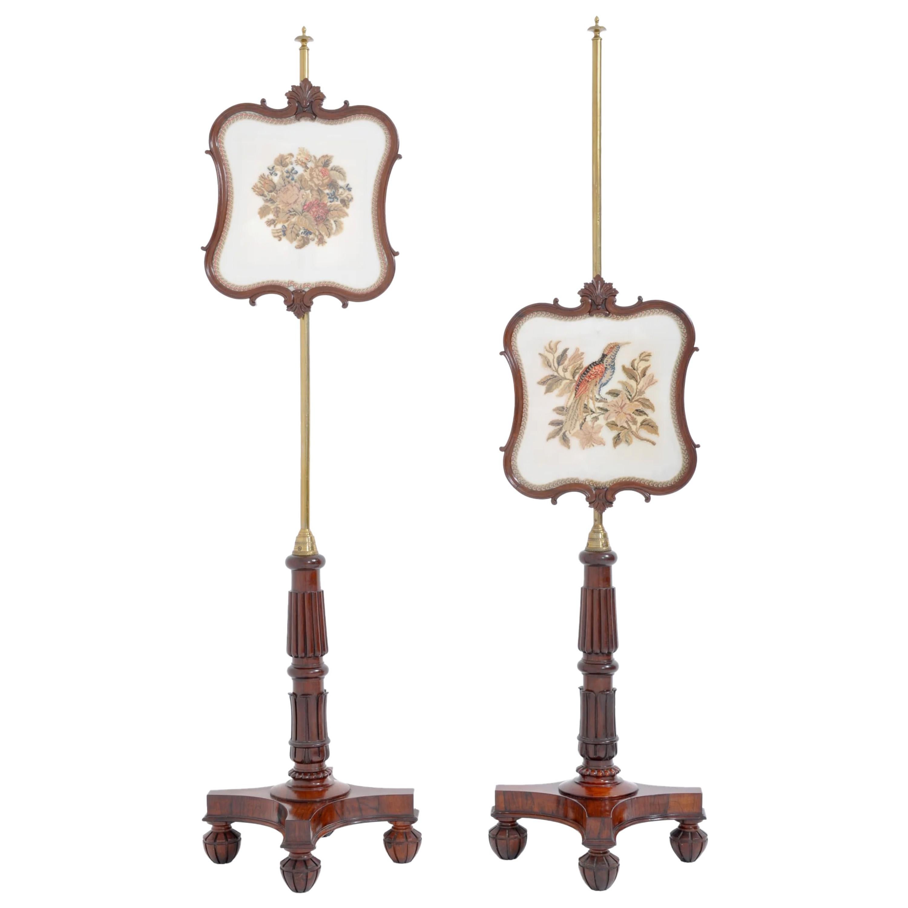 A fine pair of Antique 19th Century English William IV Brass and Rosewood Needlepoint Fire/Pole Screens, Circa 1830. The screens having brass stems with turned finials mounted with adjustable shield-shaped screens with the original needlepoint. The