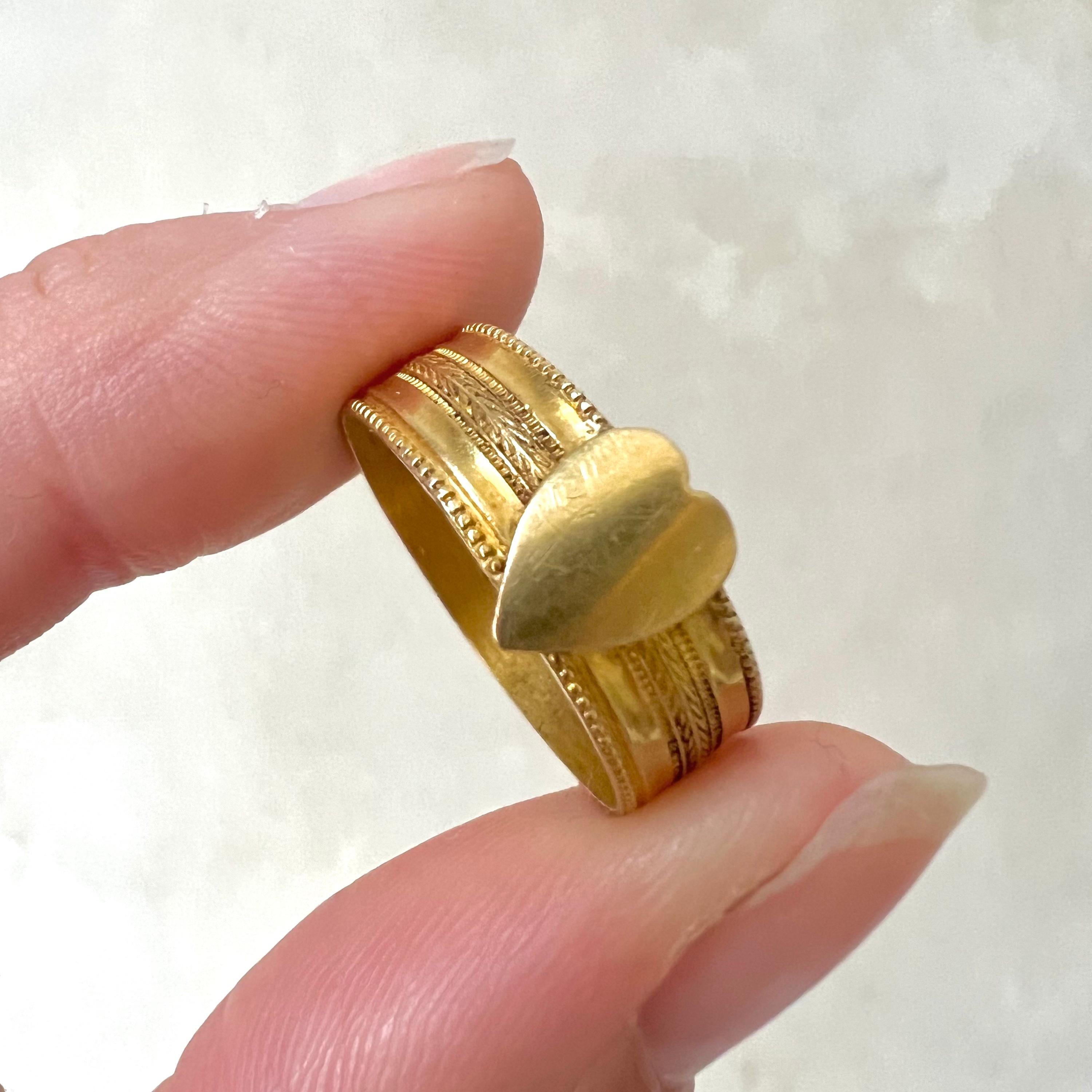 This enchanting 19th century 18 karat gold ring, is a true testament to the elegance and romance of a bygone era. Crafted with the utmost care and attention to detail, this stunning piece is adorned with a delicate heart motif, making it a timeless