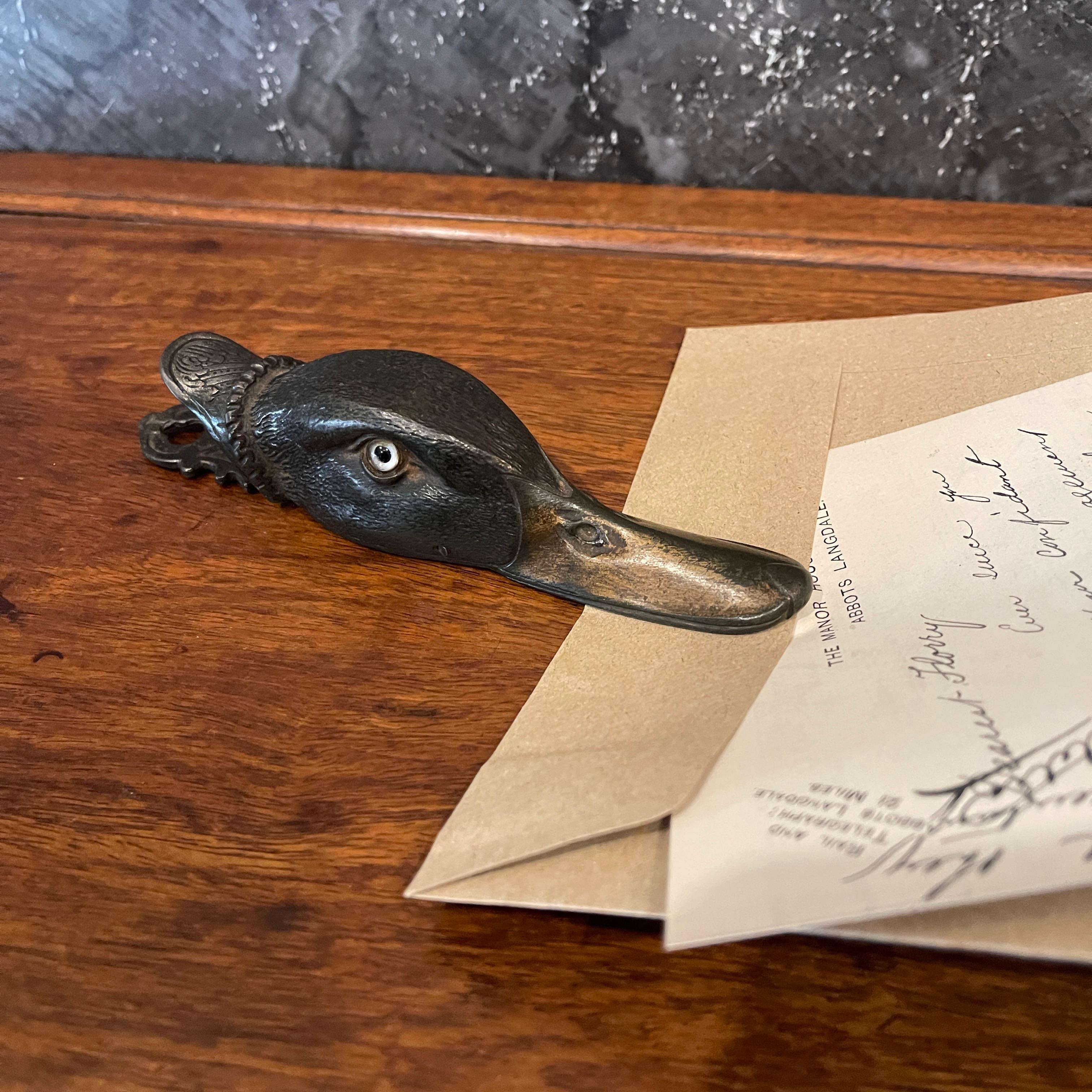 Introducing a captivating Antique 19th century Figural Bronze Duck Clip / Letter Holder. This exquisite piece showcases the artistry and charm of the 19th-century craftsmanship. Skillfully cast in bronze, the figurine depicts an adorable duck with