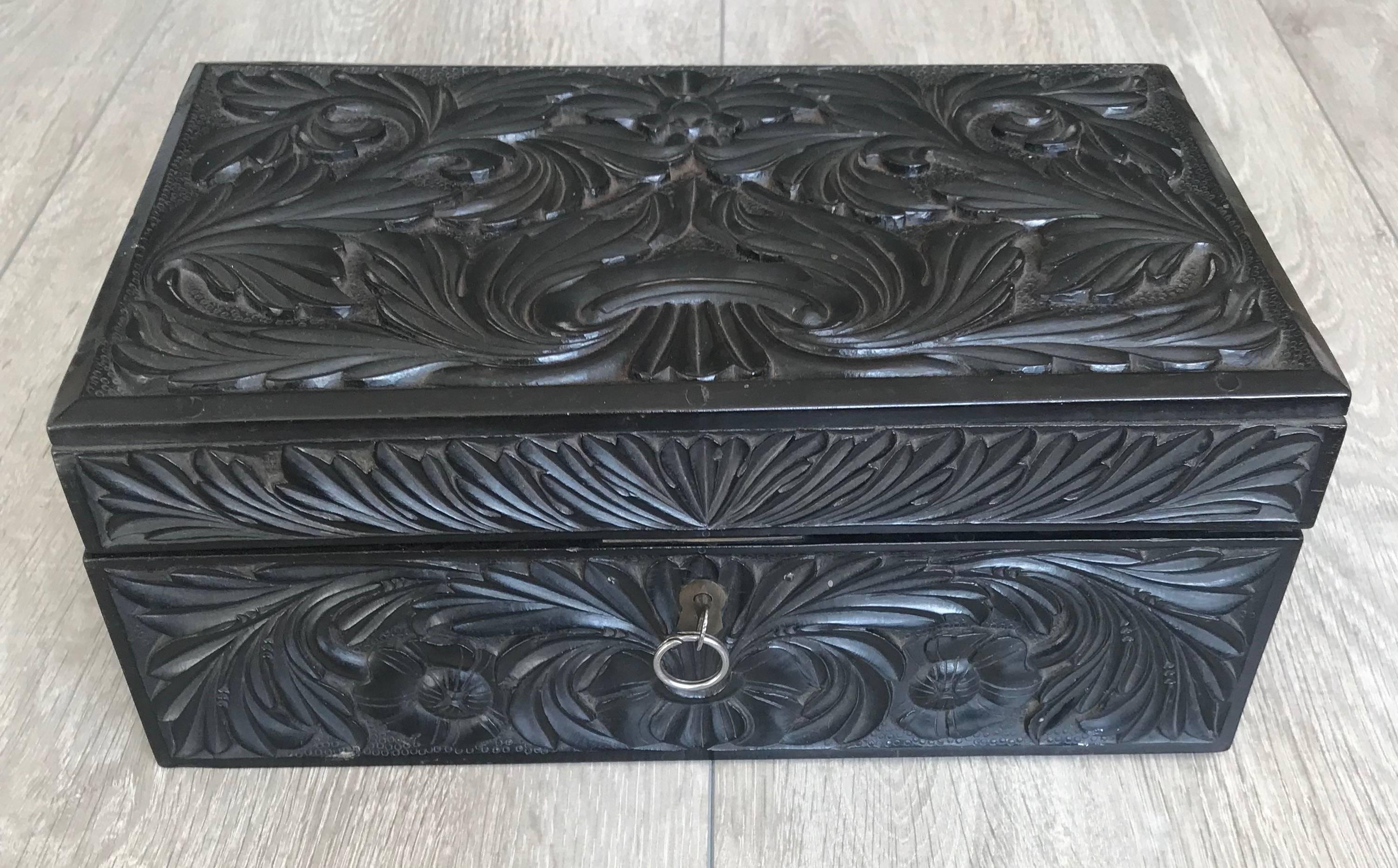 Rare Colonial era, all handcrafted darkwood box.

The deep and perfectly symmetrical flowers and leafs on all sides of this marvelous box are extra impressive when we take into account that they are all hand-carved out of one of the hardest woods on