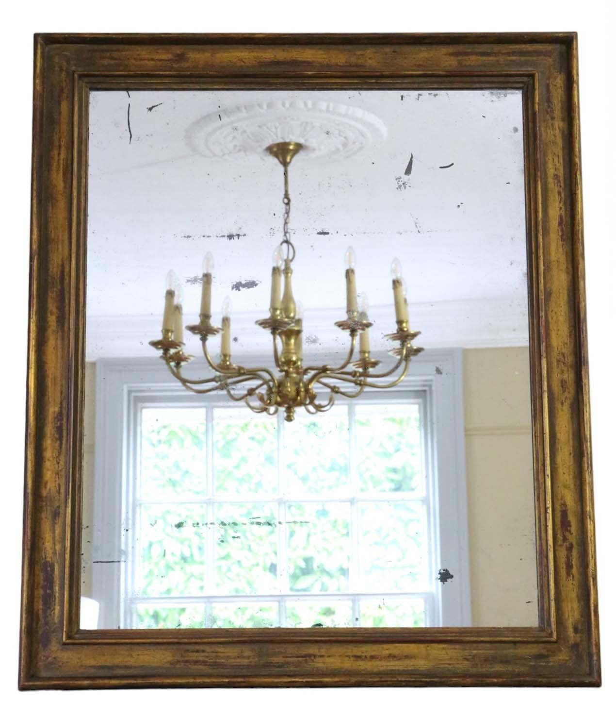 Antique large gilt overmantle wall mirror from the 19th Century, boasting fine quality craftsmanship.

This mirror captivates with its simple yet striking design, adding character to any suitable space. The frame is sturdy and free from loose joints