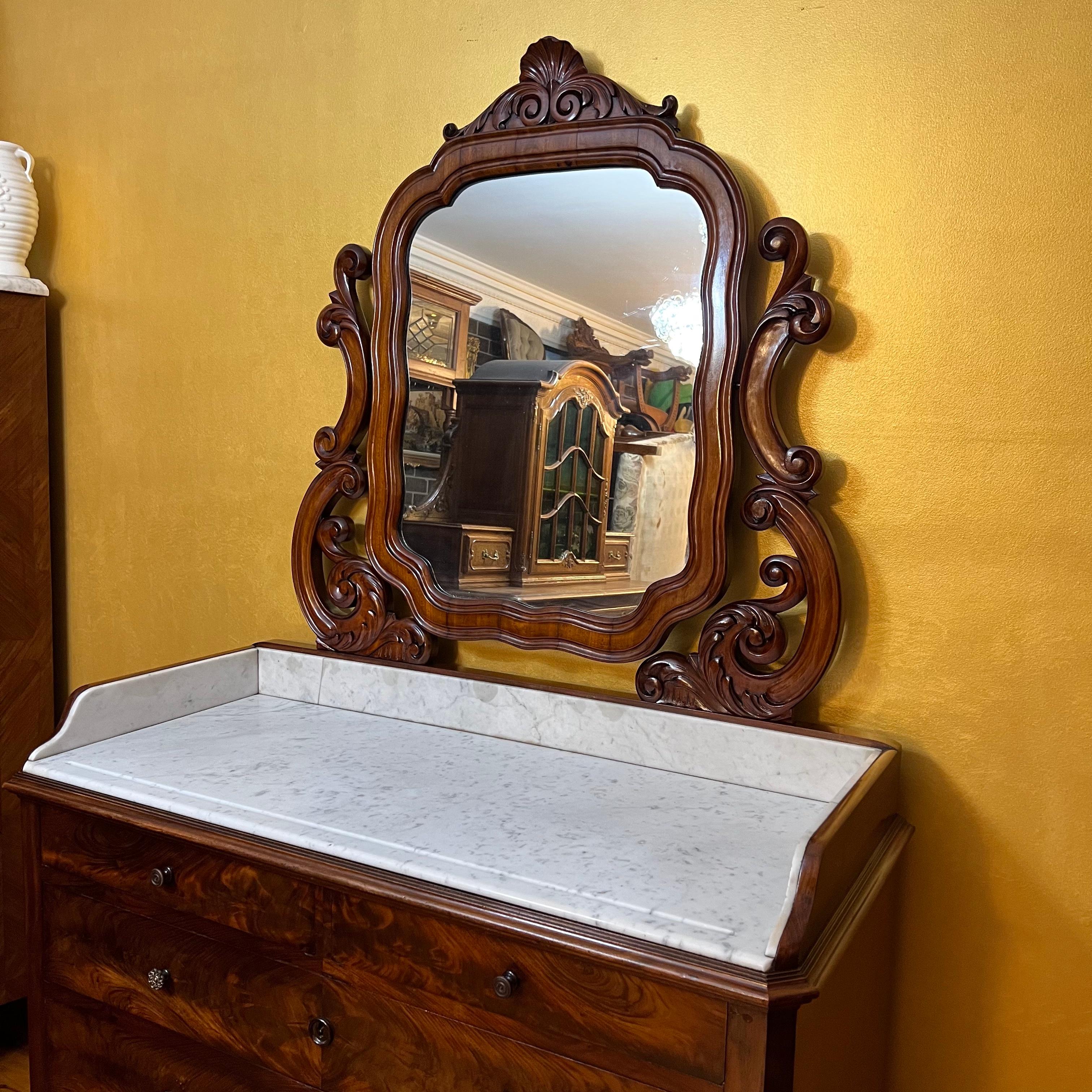 Carved detail mirror top with marble top, marble on sides have cracks in it but is held in place, have six drawers, this item has been French Polished 

Circa: 19th Century 

Material: Flame Mahogany 

Country Of Origin: