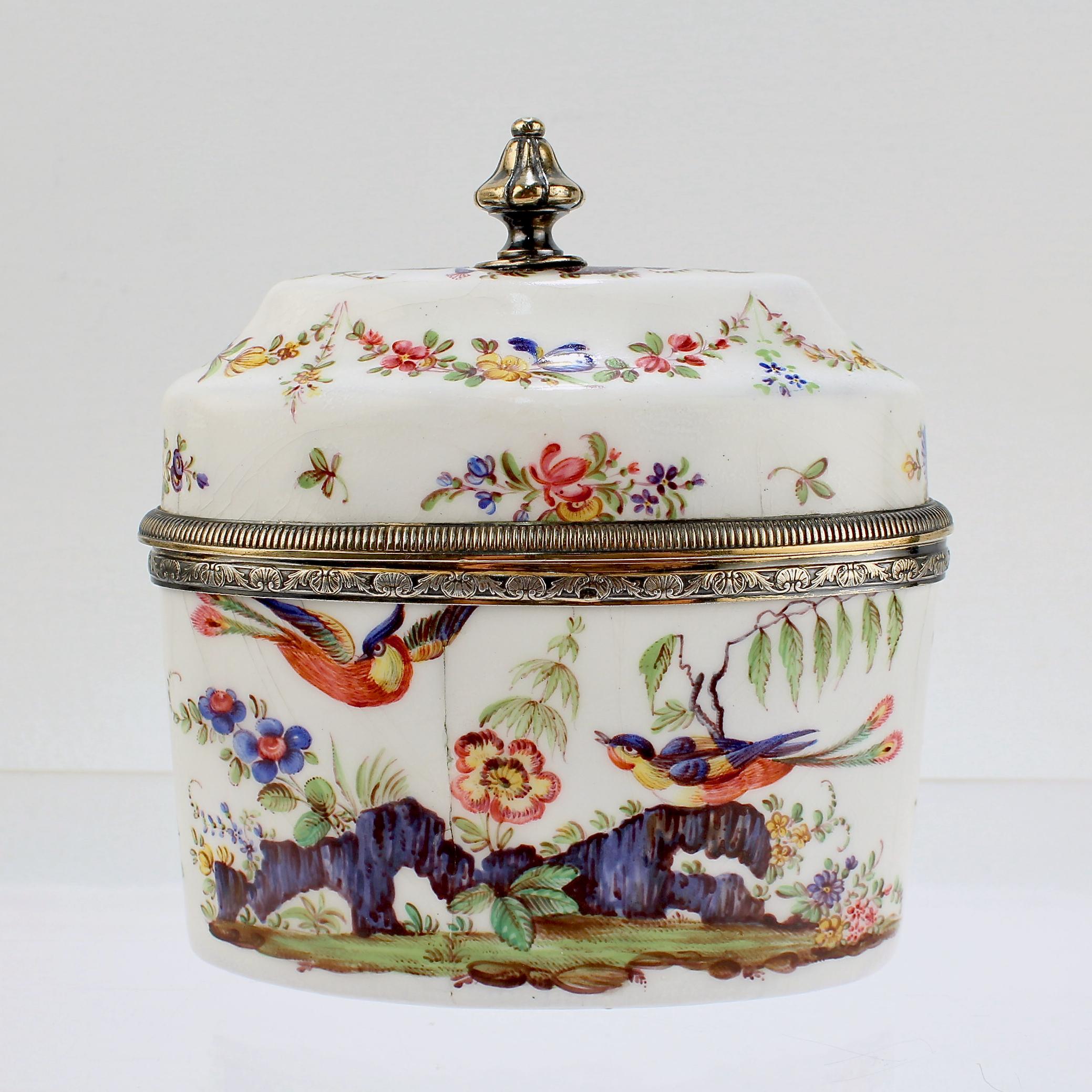 A fine antique French enamel tea caddy.

Mounted with gilt silver mounts.

By Risler of Paris.

Decorated with polychrome birds or paradise, rock outcroppings, and flowers/floral swags throughout. 

Simply a wonderful early tea caddy!