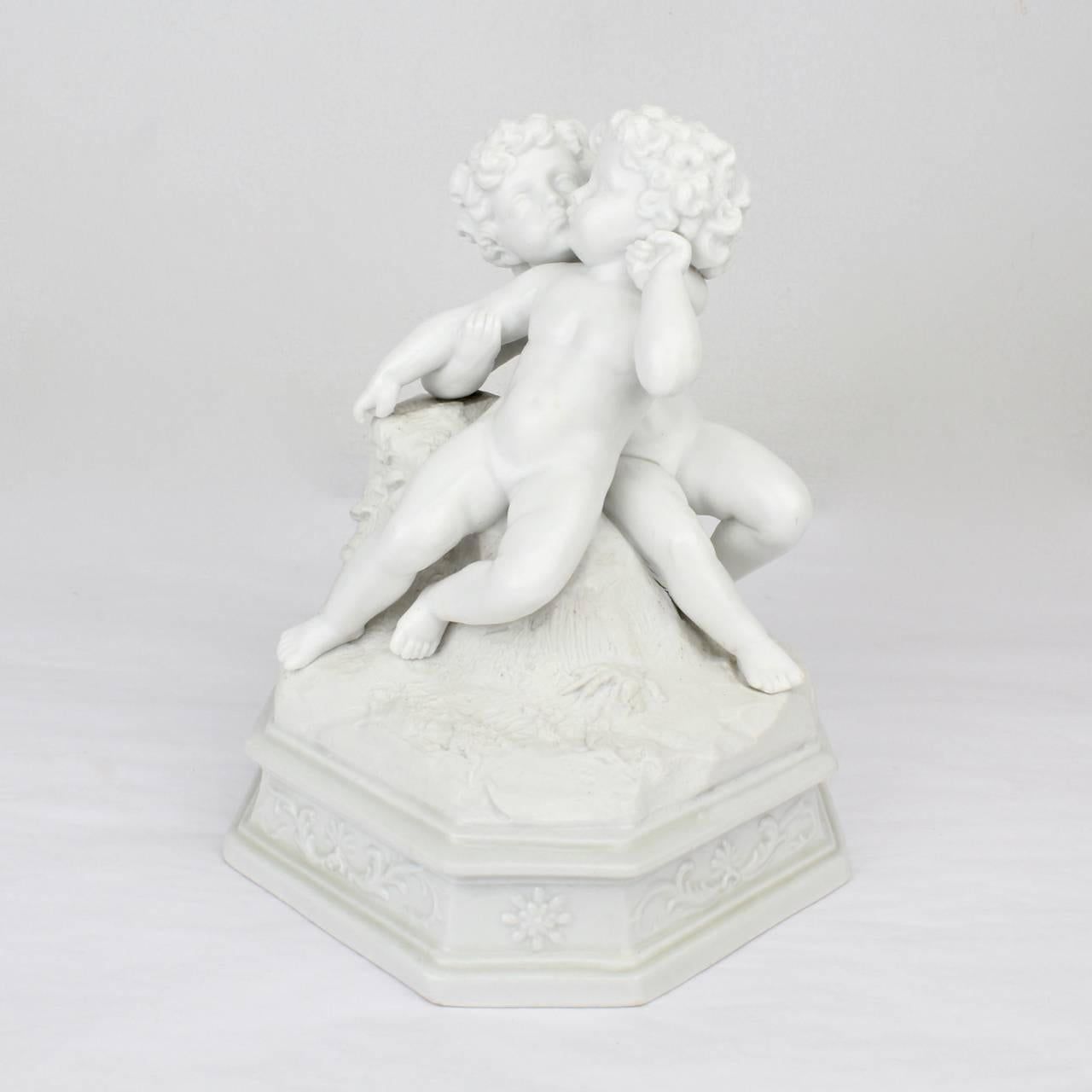 A wonderful antique 19th century figurine of two putti in an embrace - one putto wrapped in the other's arms with faces at a tenderly close distance.

Likely French with a glazed plinth and bisque top. 

Base unmarked.

Measure: Height ca. 6