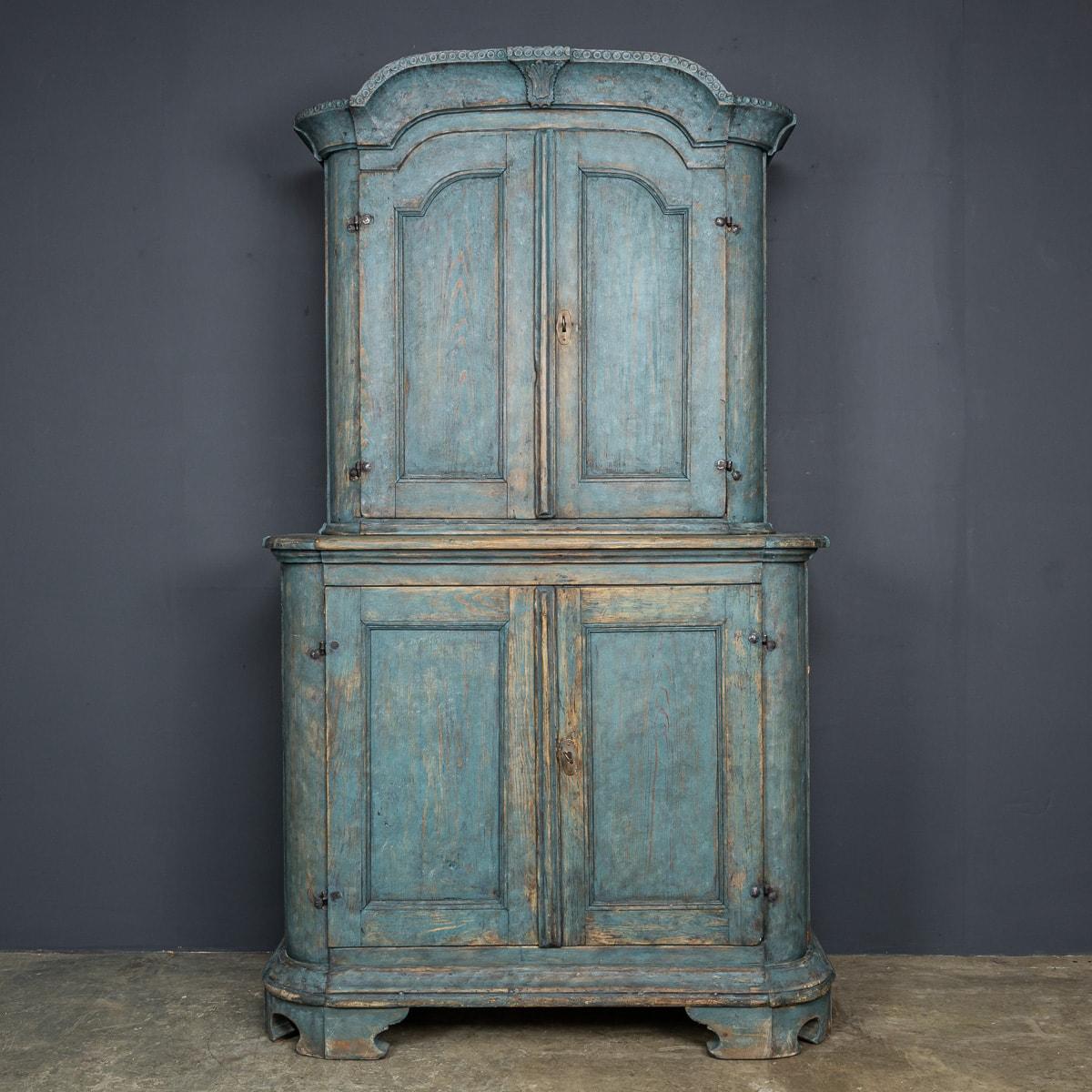 Antique 19th Century French pine cupboard, painted in a deep blue hue showcases brilliant craftsmanship. Complete with two drawers, shelves, and a plate rack in the top cupboard, and additional shelves inside the bottom cupboard, it offers ample