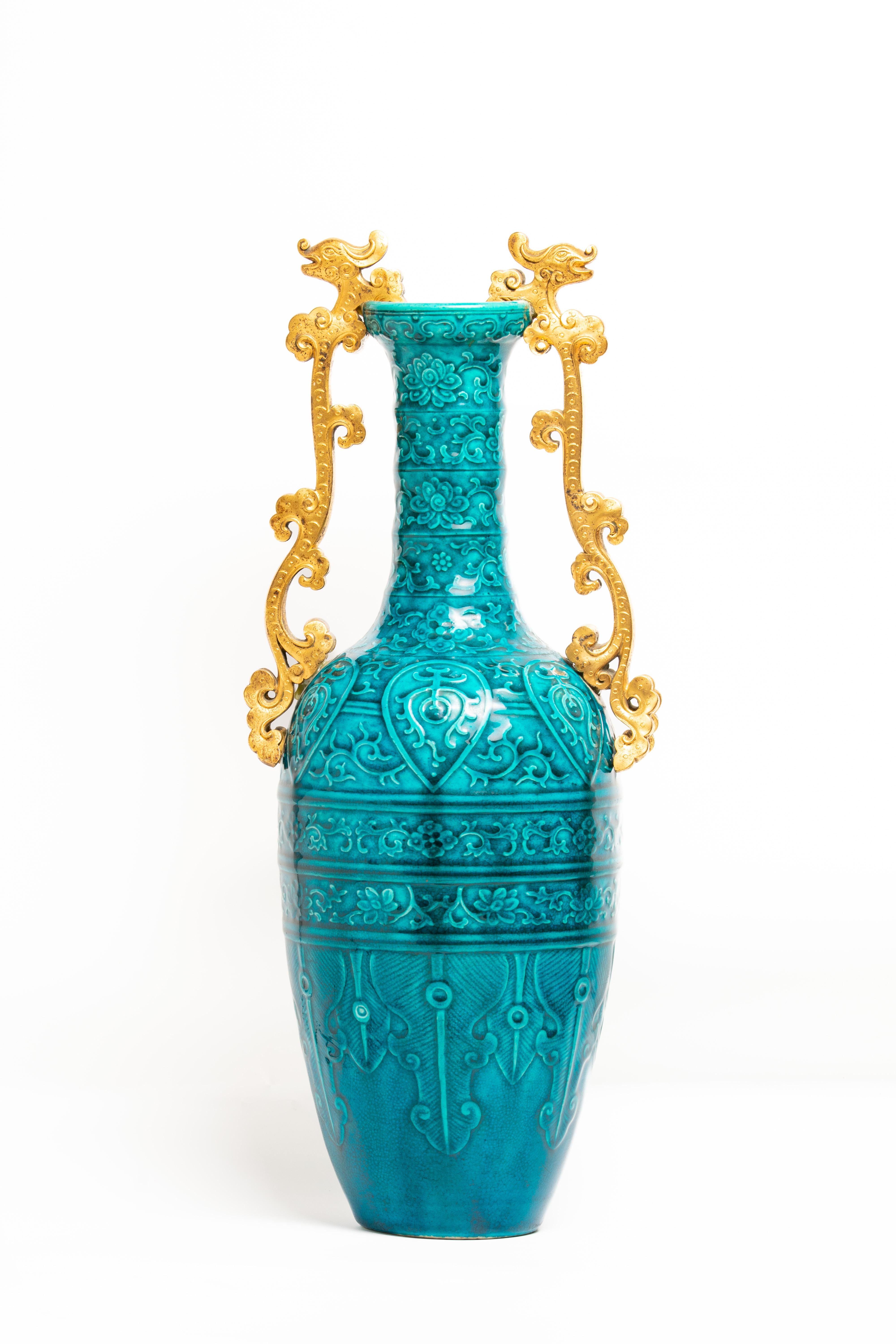 A late 19th-century French gilt bronze mounted blue vase attributed to Théodore Deck. The vase is beautifully decorated with various floral and geometric elements. The central part has six teardrops with geometrical symbols inside. The vase has a