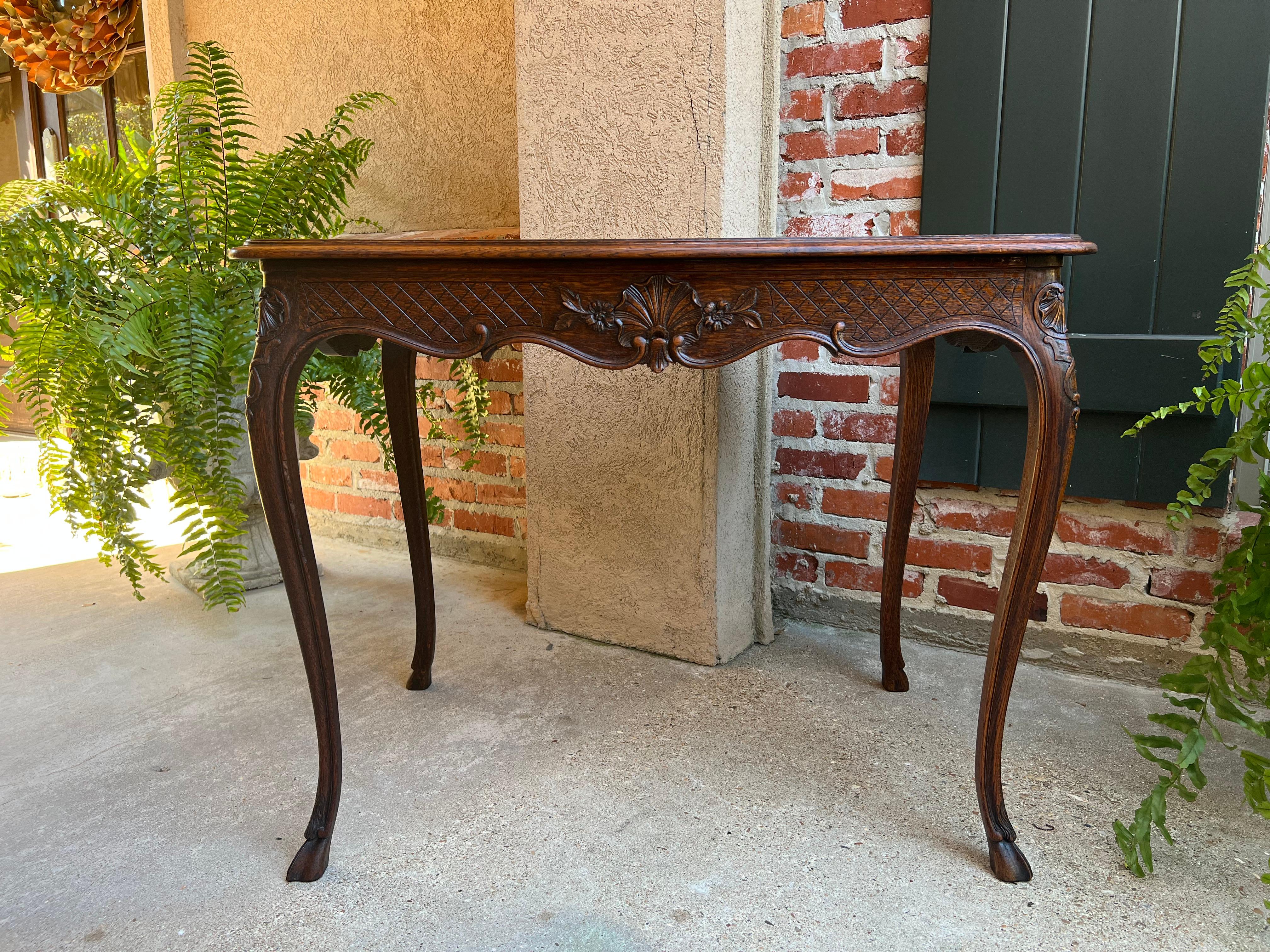 ~Direct from France~
A lovely carved French side or sofa table with classic French Louis XV style and elegance. 
Beveled serpentine edge oak table top above the contoured apron. Apron is richly carved with shell and foliate motifs amidst carved