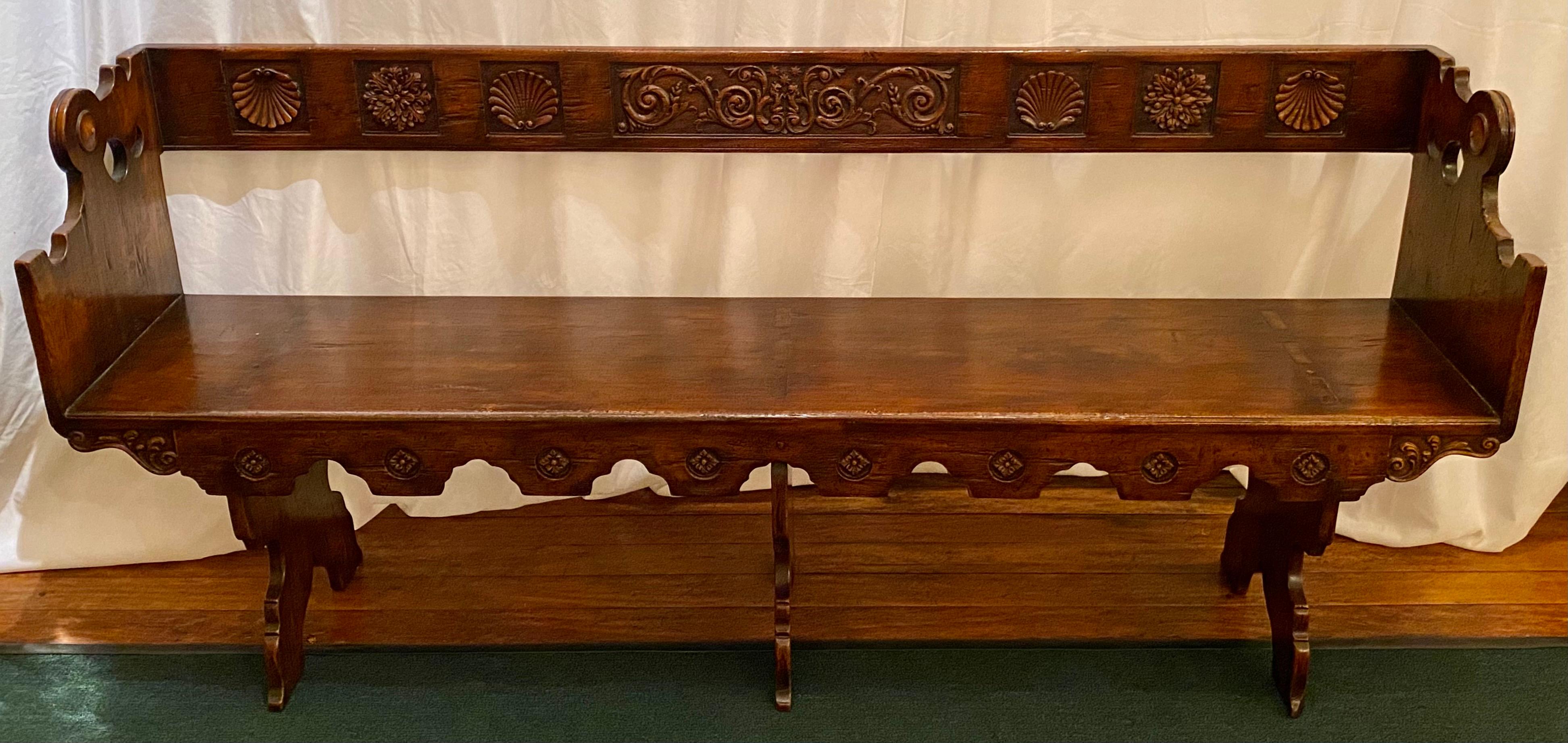 Antique 19th century French carved walnut banquette bench, circa 1880.