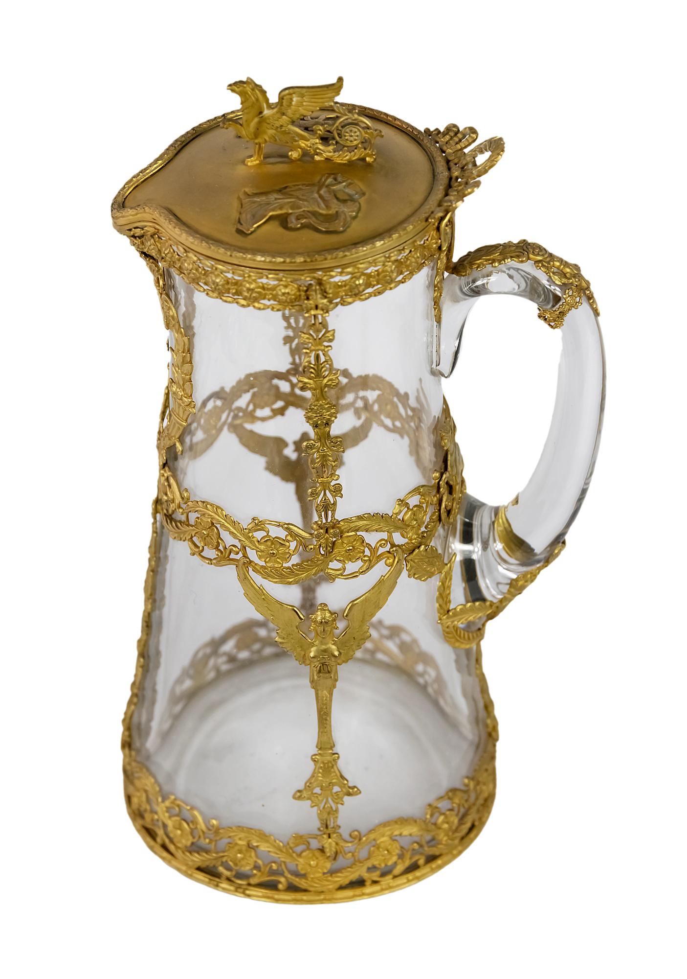 Antique 19th century French gilded bronze and glass jug/pitcher.
The glass part is decorated with Empire style gilded bronze decor.