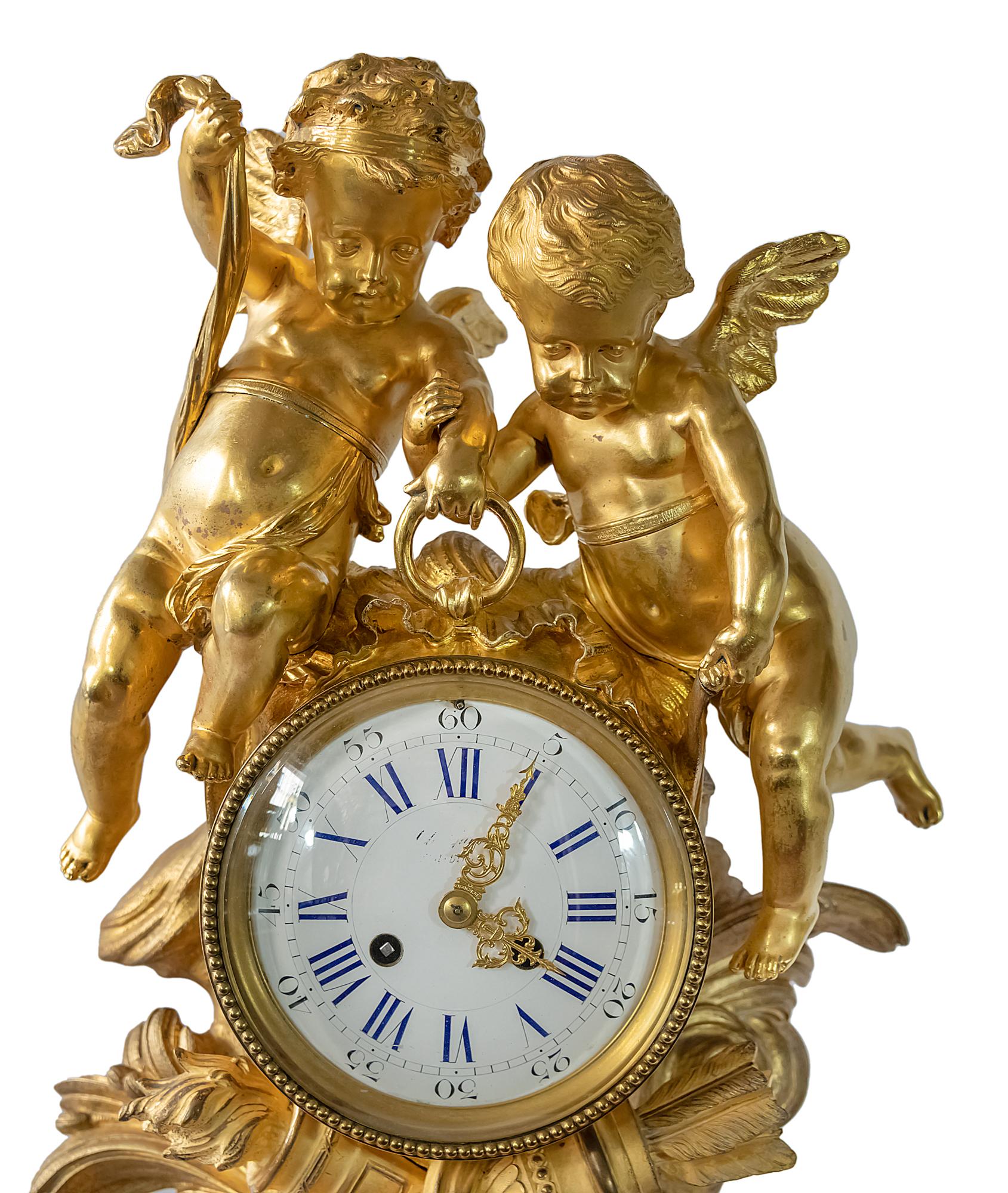 Large antique 19th century French gilded bronze mantel clock surmounted with two angels holding the dial.
The enamel dial numerals are hand painted in cobalt blue color.
Marked and numbered inside the clock movement.
Weight: 19 kg.
Date of