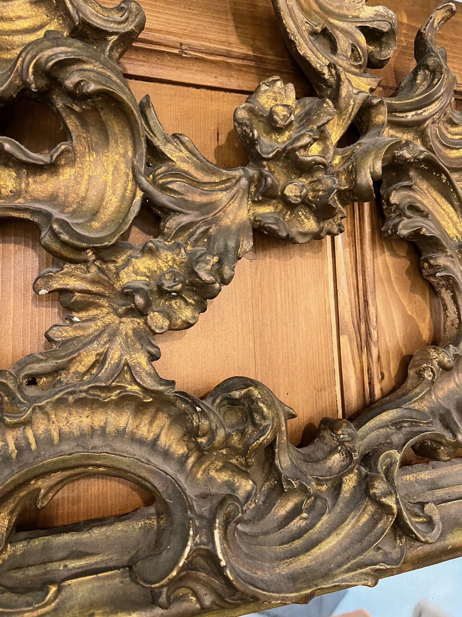 A wonderful late 19th century antique French gilt wall mirror. This mirror has a very elaborate gesso frame that is simple amazing. Overall in good condition but does need some repairs to the frame shown in the photos and video. 