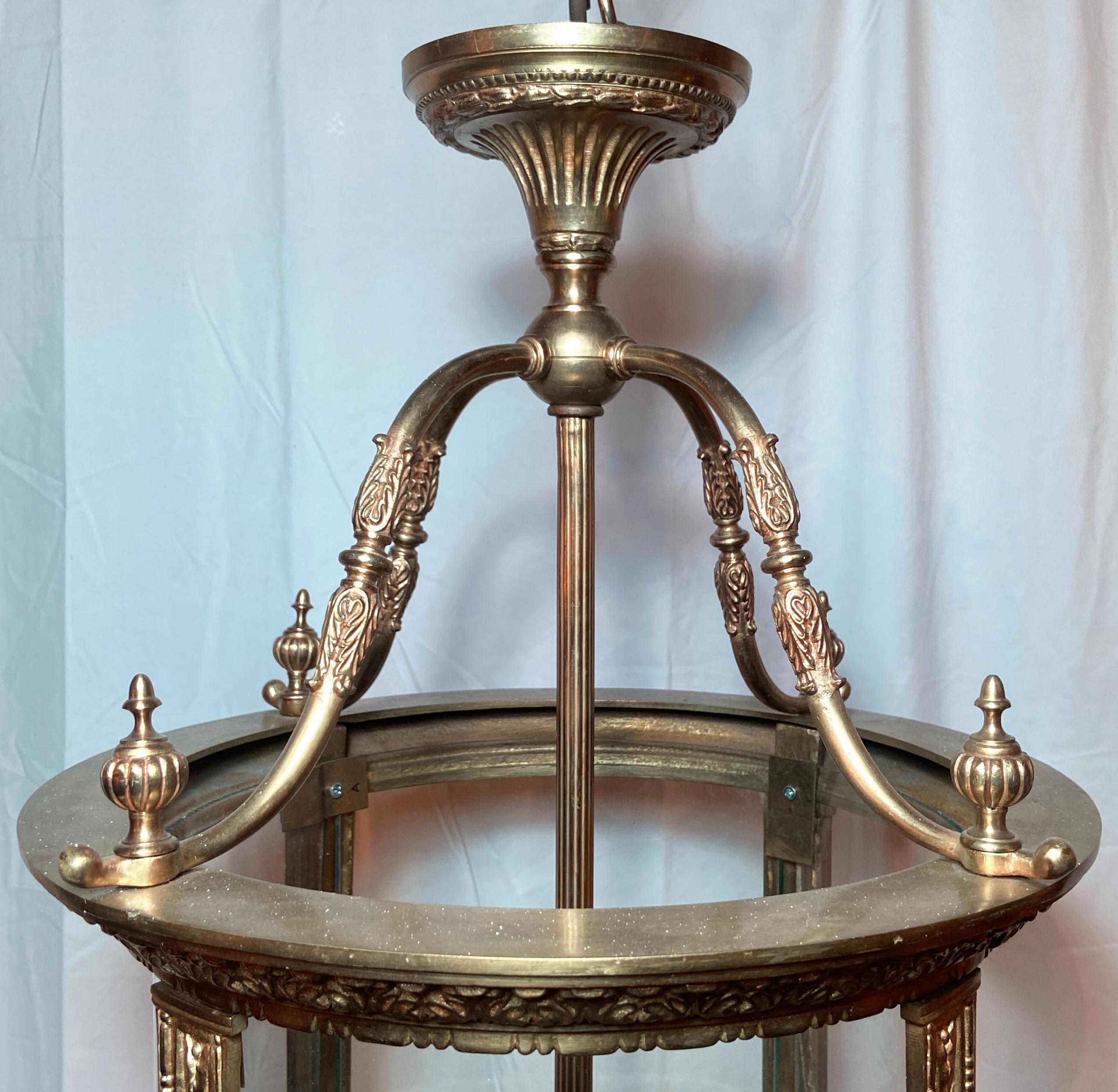 Antique 19th century French gold bronze lantern with engraved glass.
Glass has a figural starburst engraving at center.