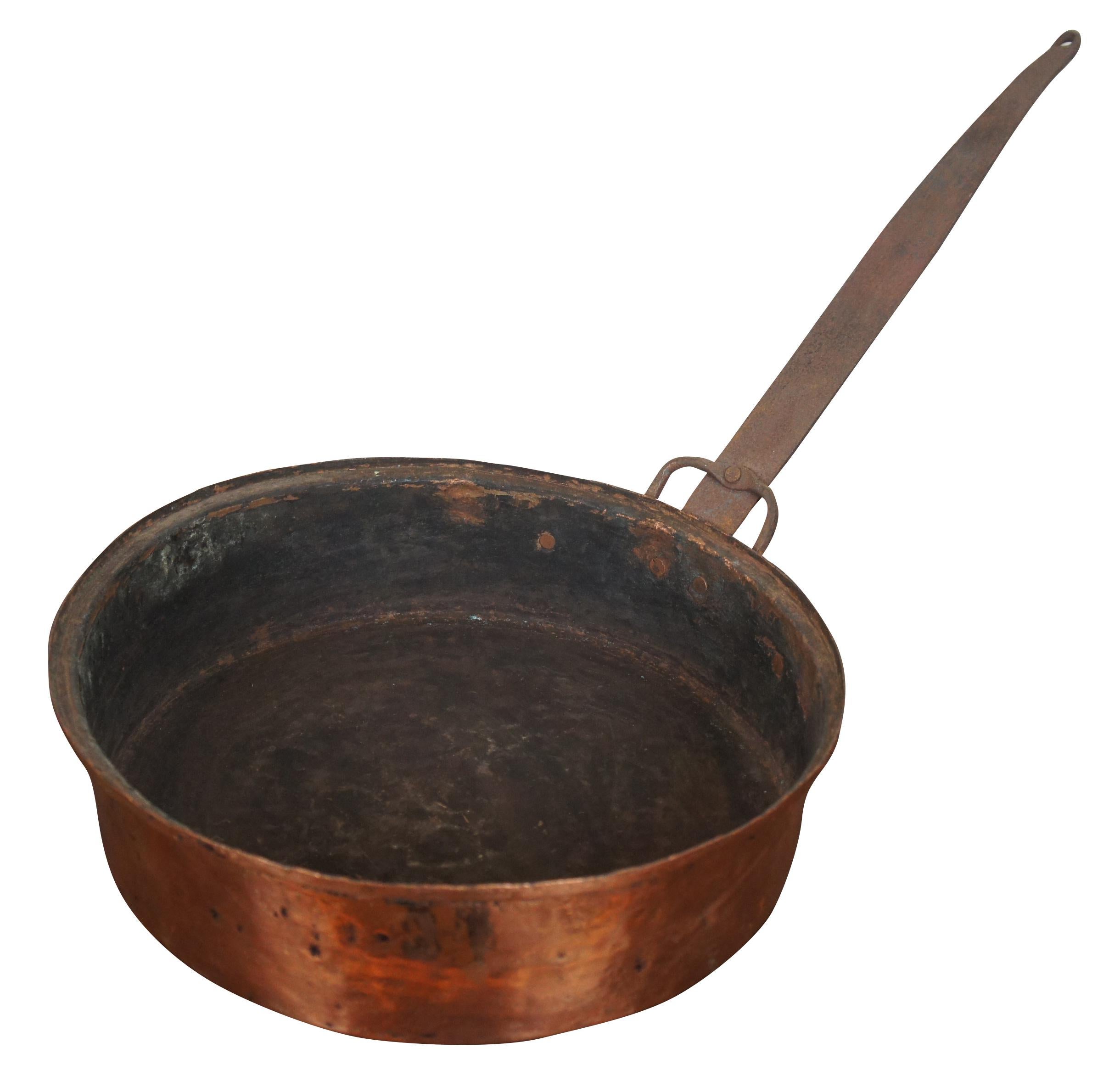 Antique 19th century French hammered copper frying pan featuring forged cast iron handle. Measure: 12