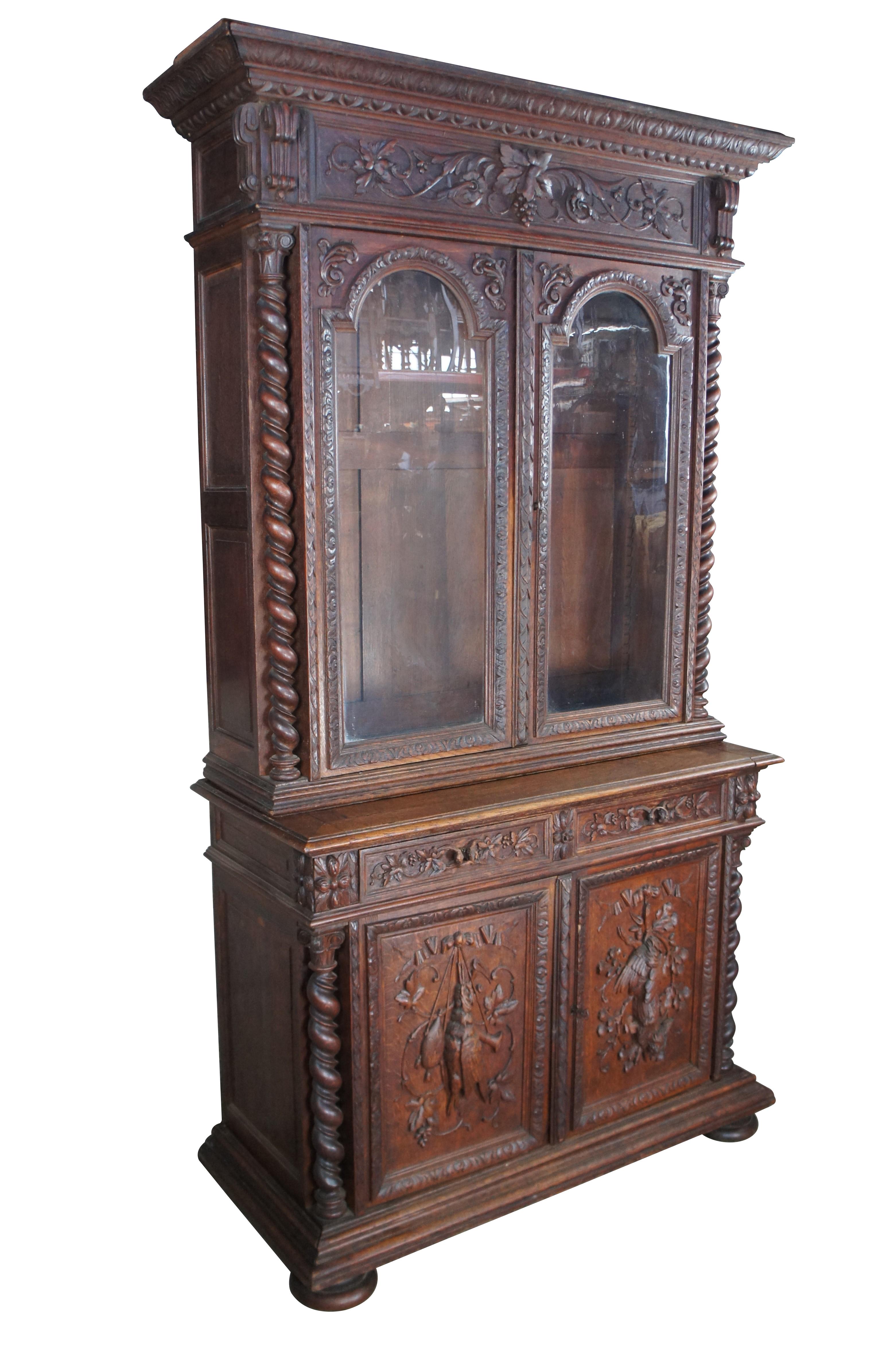 Exceptional Antique 19th Century French Henry II / Renaissance Revival Hunt Cabinet. Hand carved from oak with a large upper display portion flanked by barley twisted columns. Opens to two shelves. The lower storage area of the cabinet features