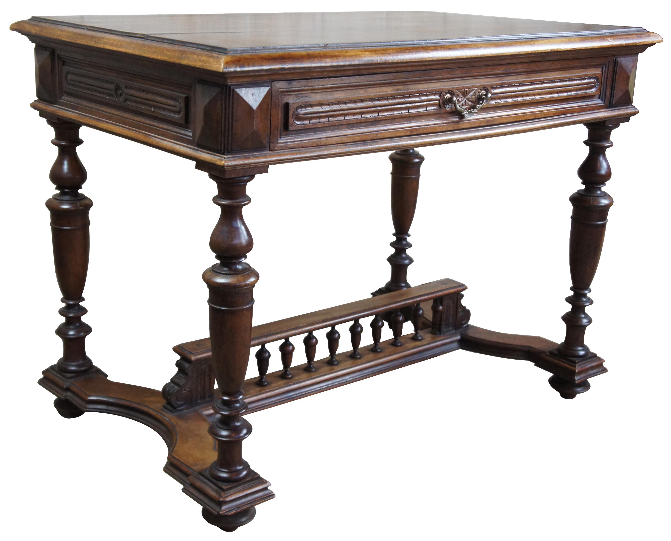 French library table in Henry II style, circa 1890s. Made from walnut with a long carved central drawer over turned legs and trestle base. Brass drawer pull features two delphins (dolphins) connected by a shell. The desk is carved in traditional