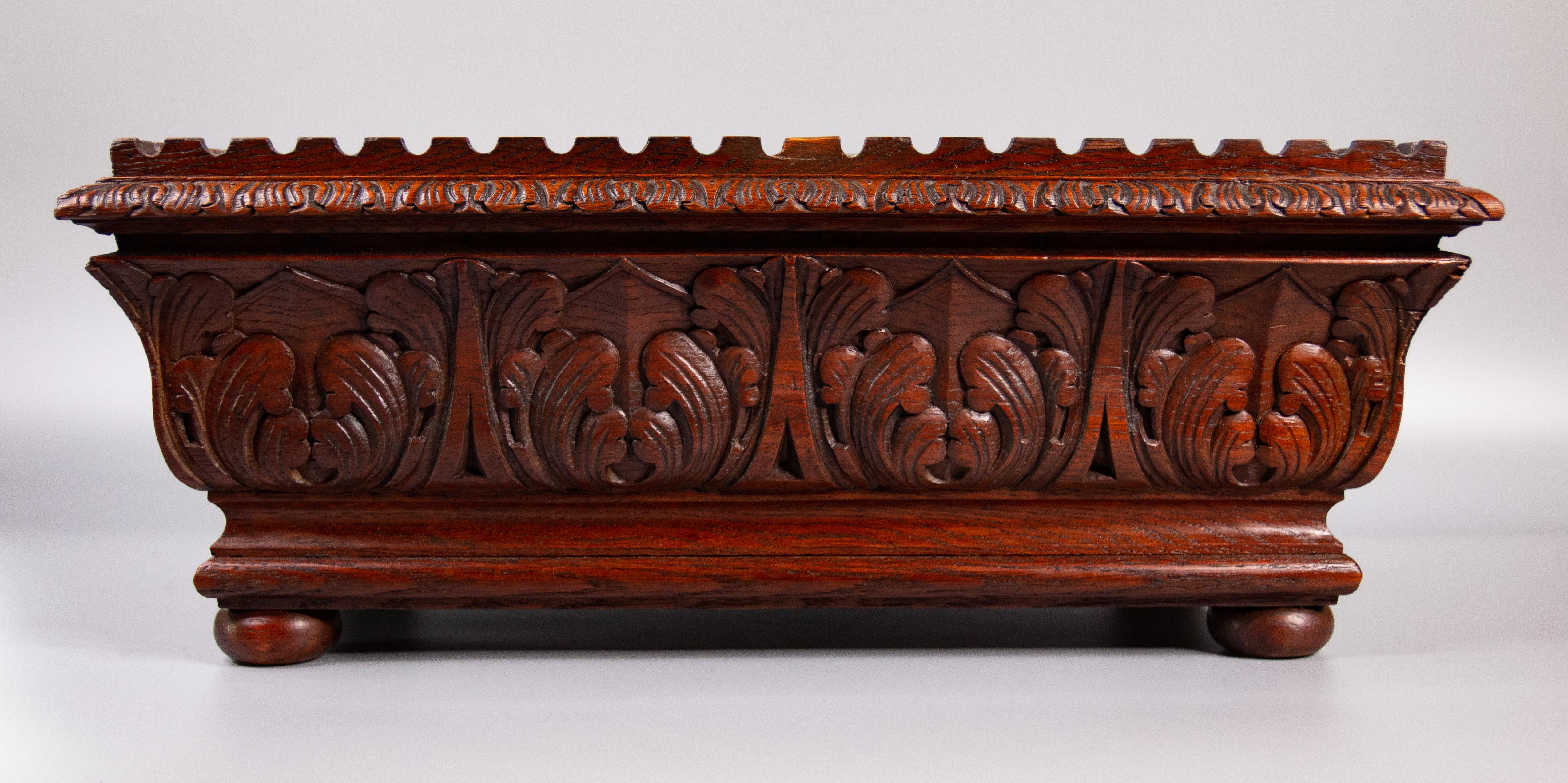 A superb 19th century French hand carved mahogany jardiniere or planter with original tin liner. It's a nice large rectangular size, solid and heavy, with very fine carving and bun feet. It would make a fabulous table centerpiece displayed with a