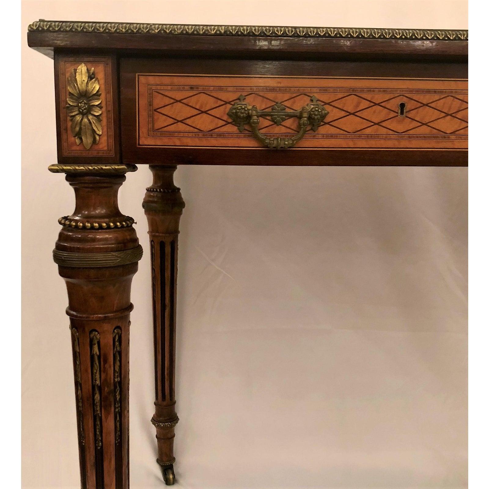 Antique 19th century French museum quality inlaid writing table with bronze trim. Excellent condition. Such a lovely antique piece!.
 