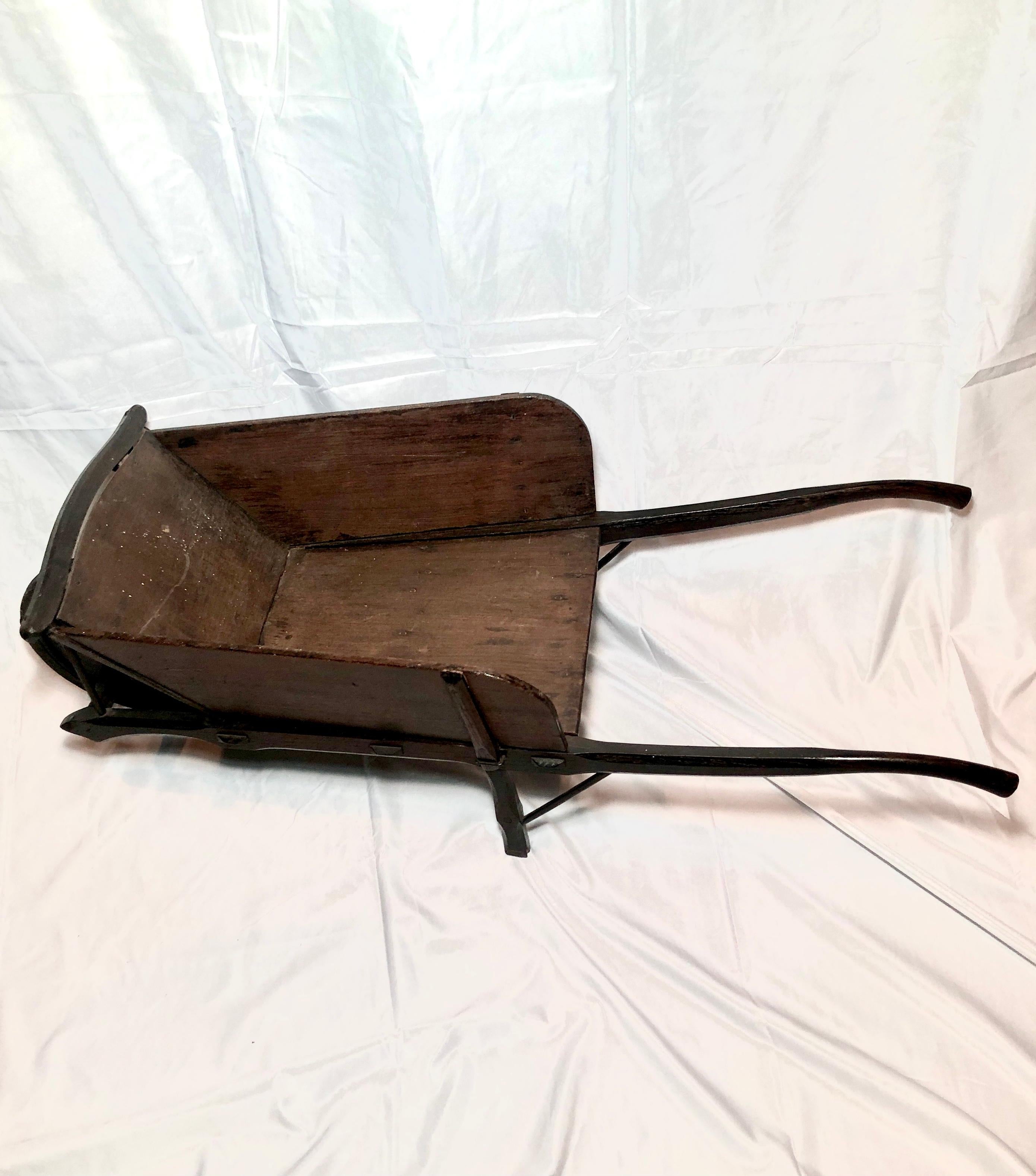 Antique 19th century French provincial wooden wheel barrow.