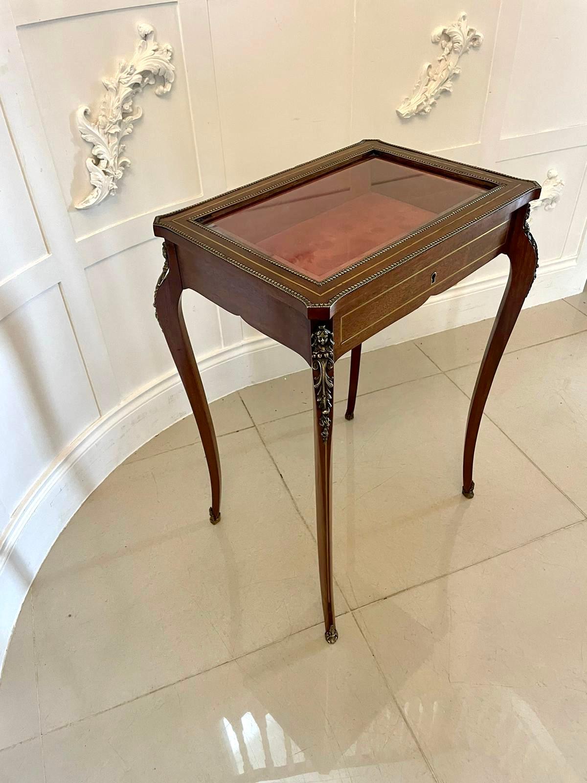 Antique 19th century French quality brass inlaid mahogany bijouterie cabinet having a quality mahogany brass inlaid bevelled edge, glass lift up top, shaped mahogany brass inlaid frieze standing on shaped cabriole legs with ornate ormolu mounts and