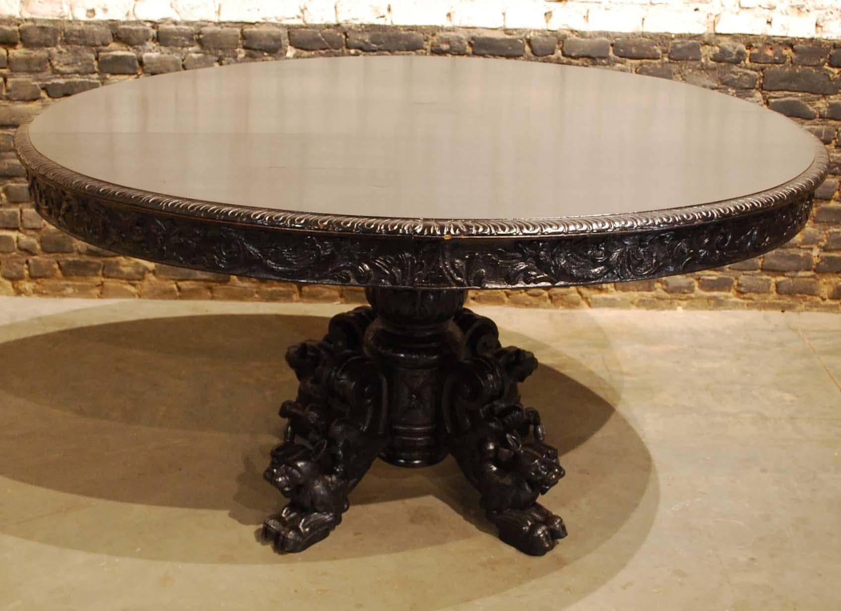 This 19th century French Renaissance oval hunt table was sculpted from solid oak and features elaborately carved winged foxes beautifully rendered on the scrolled legs below.
Support is provided by a large carved urn style pediment at the center.