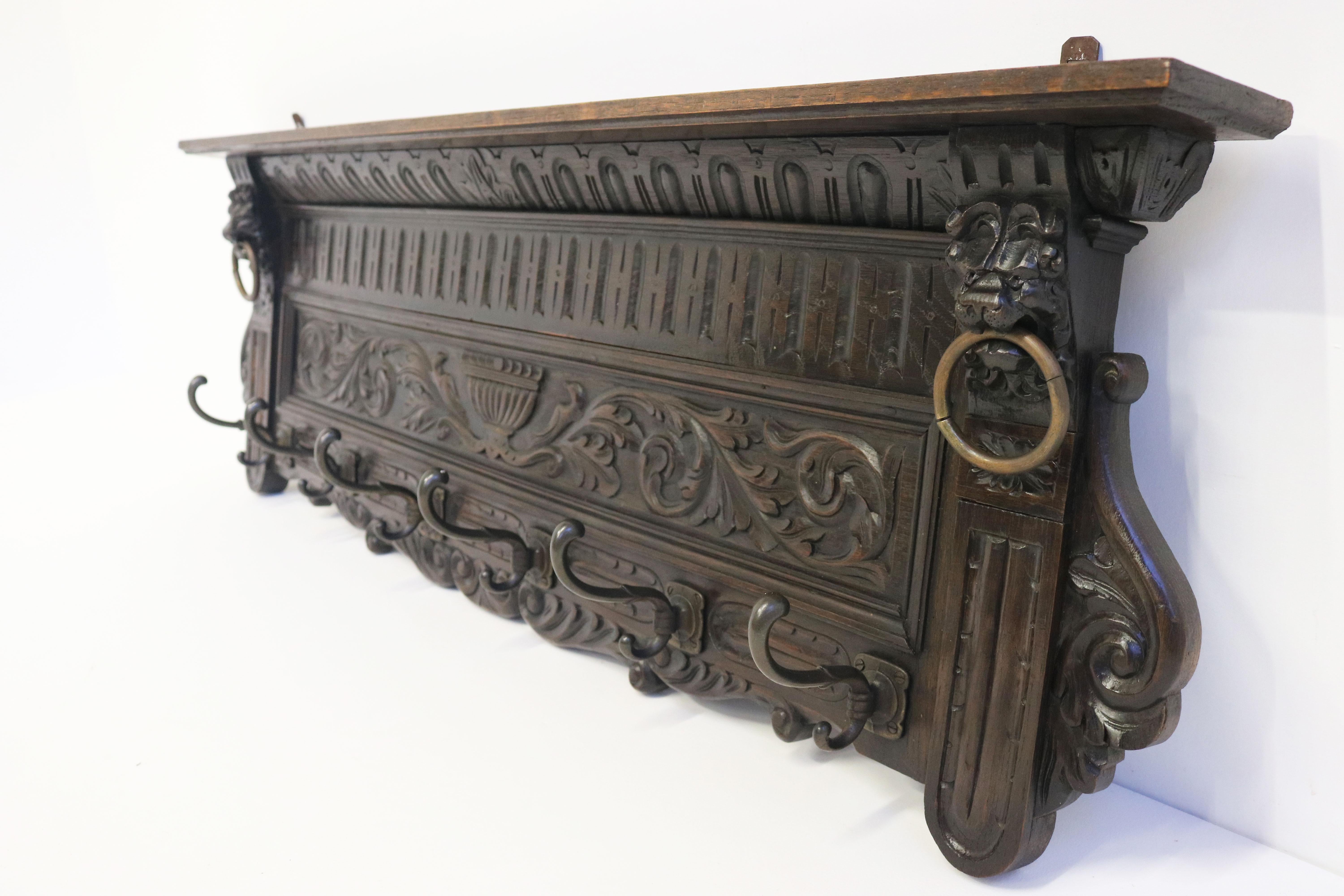 Impressive & practical! This 19th century French Renaissance Revival coat rack. 
The lion masks hold their original bronze rings and look most impressive. 
Decorate your hallway with this dark oak hand carved antique  
The coat rack is highly