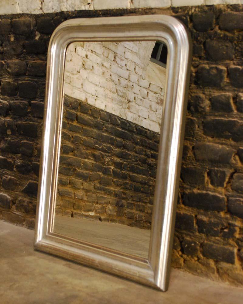 A beautiful completely silver leaf gilt Louis Philippe mirror. 
The mirror is made in Northern France and dates circa 1880. The mirror frame is has a solid pine base and was smoothened with gesso and grey black base color. The silver leaf was