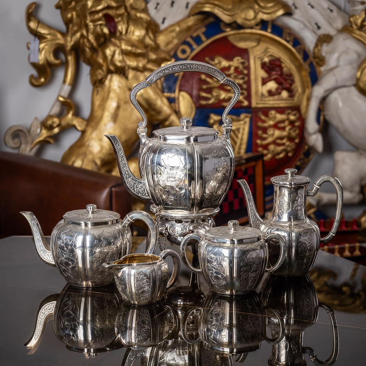 Antique late 19th century French exceptional tea service, comprising: a silver plated hot water kettle, silver teapot, silver coffee pot, silver sugar bowl and silver cream jug, melon shaped with panels chased with chrysanthemums and scrolls on a
