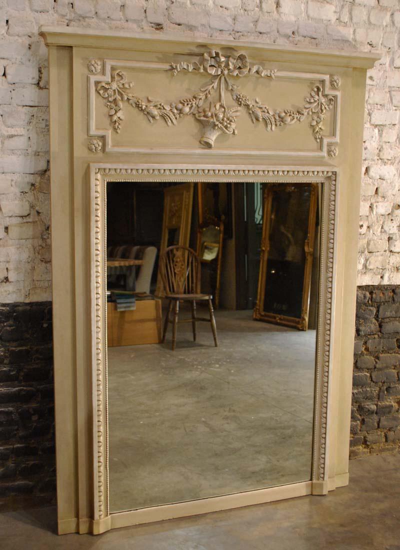 A beautiful pastel colored trumeau mirror that was made in France, circa 1890.
The mirror frame has its original mirror that came with the frame. The mirror frame has a gadrooned edge and a pearl beading surrounding the glass. The trumeau above the