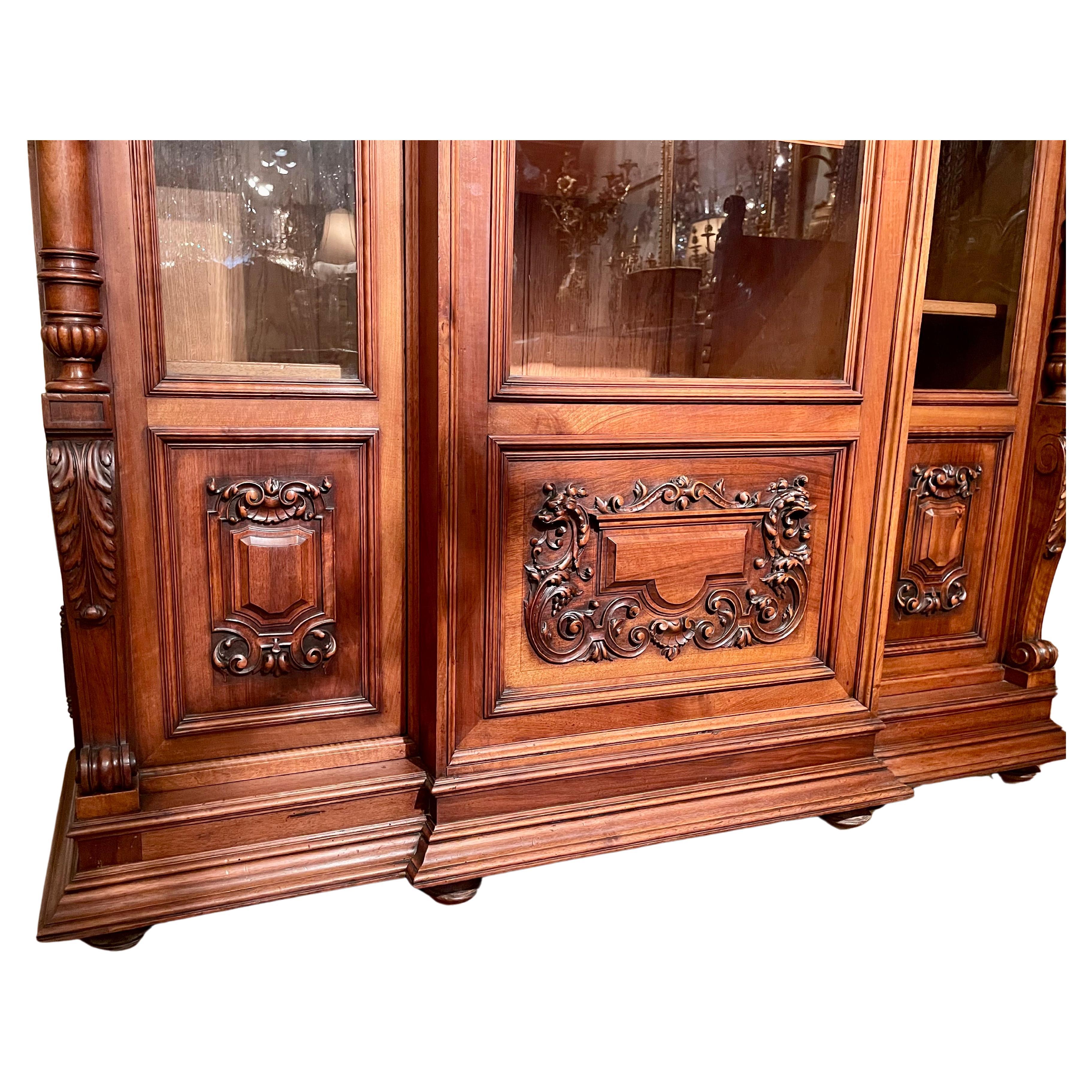 Antique 19th century French walnut cabinet with fine carving and proportions.