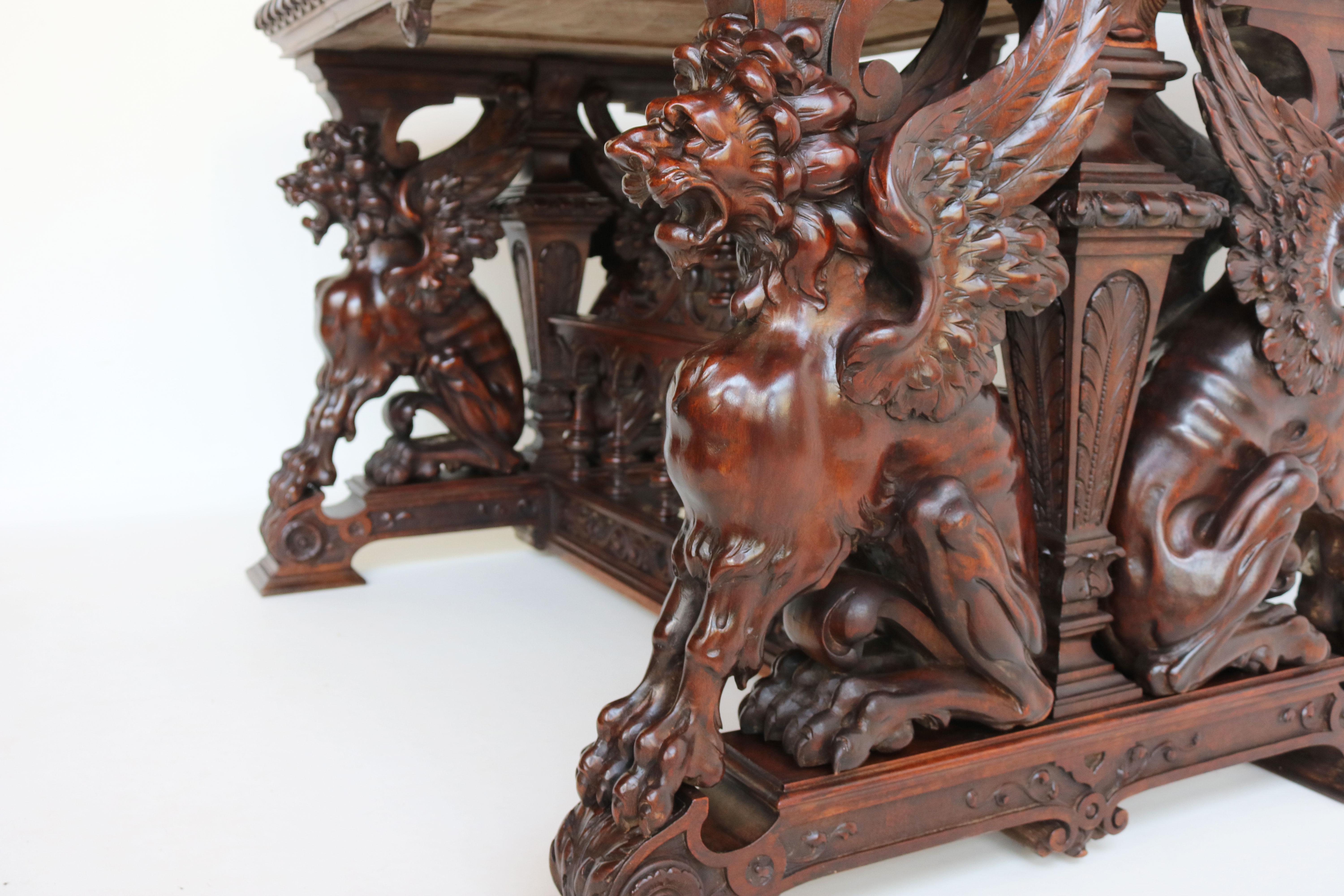 This exquisite Renaissance writing table / desk by Victor Aimone was crafted in 1890 from solid walnut wood. It features four stunning Gryphons that have been masterfully carved into the woodwork, they are completely free standing openly carved and