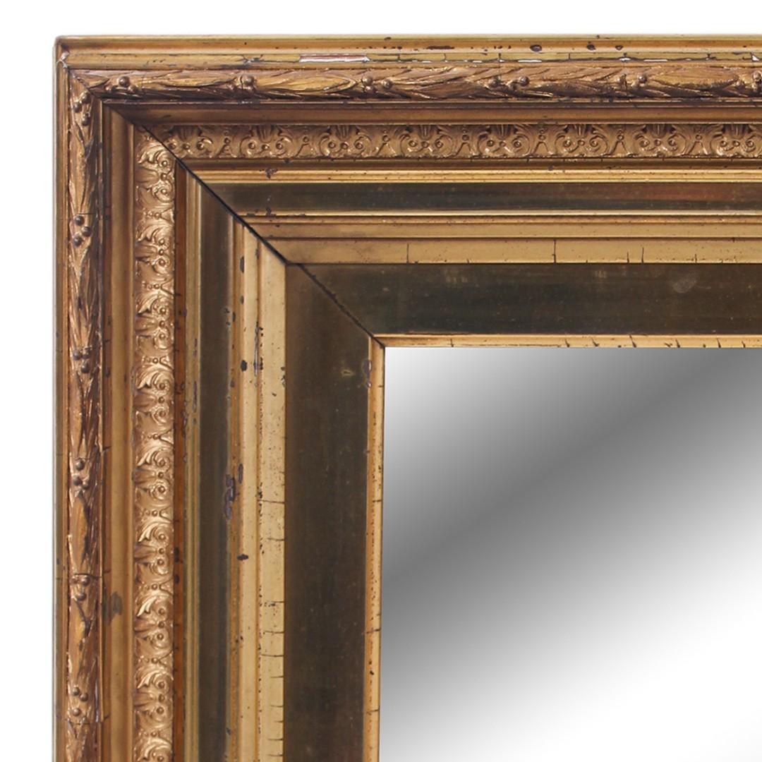Antique gilded gold wall mirror. USA, late 19th century. Features a rectangular shaped frame and original mirror.