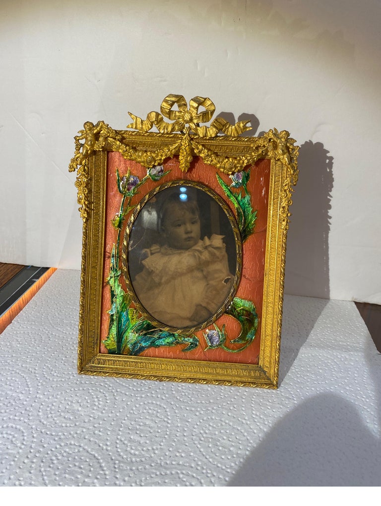 Magnificent elaborate gilt bronze picture frame with a guilloche inset matt. The frame with garlands and swags with original oval glass an metal back with easel.