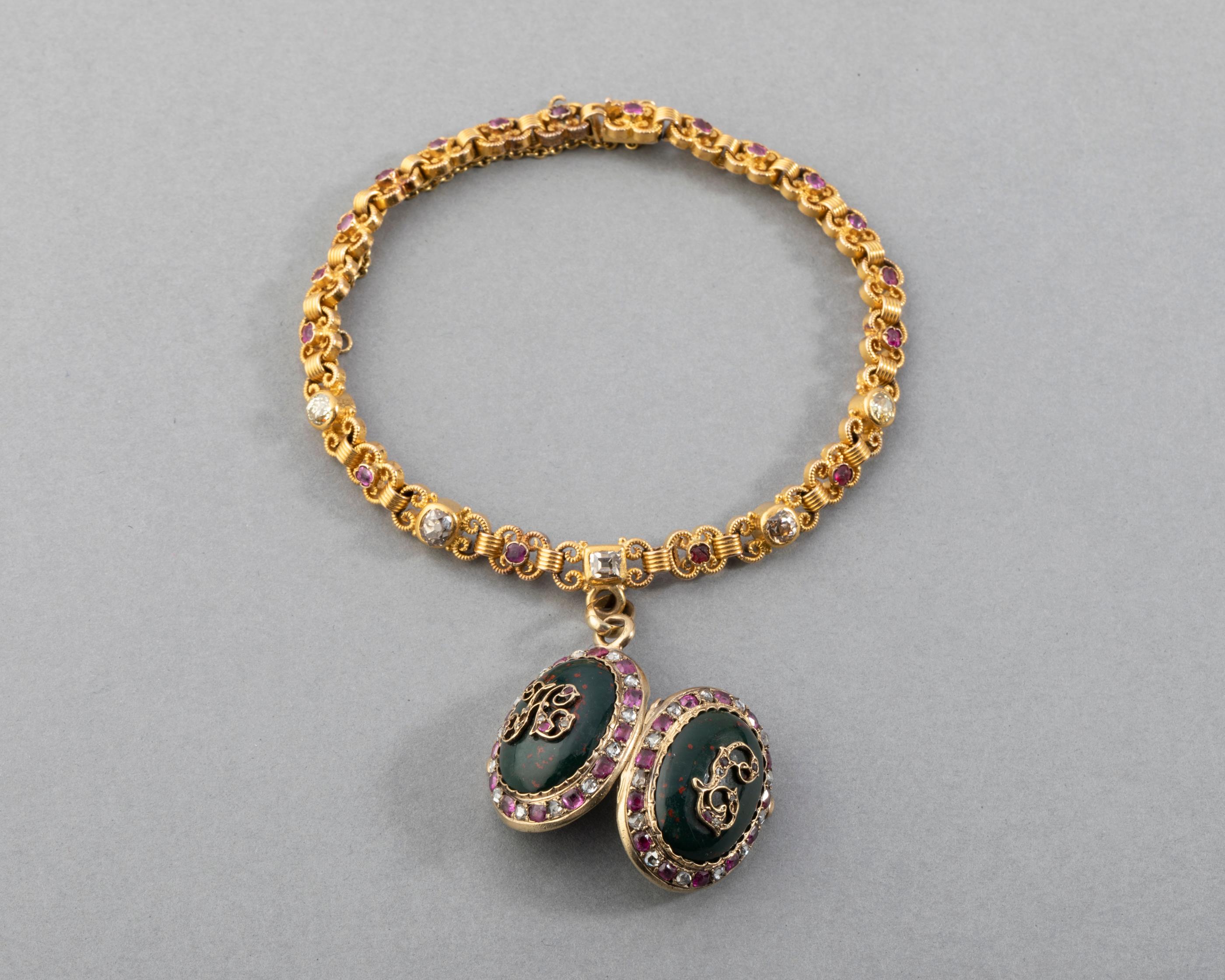 Antique 19th century Gold and Precious Stones French Bracelet

Very beautiful antique bracelet, made in France in second half of 19th century. 
Craft in yellow gold 18k (eagle marks and Rhinoceros).
The size is 18.2 cm.  5 mm width. The locket
