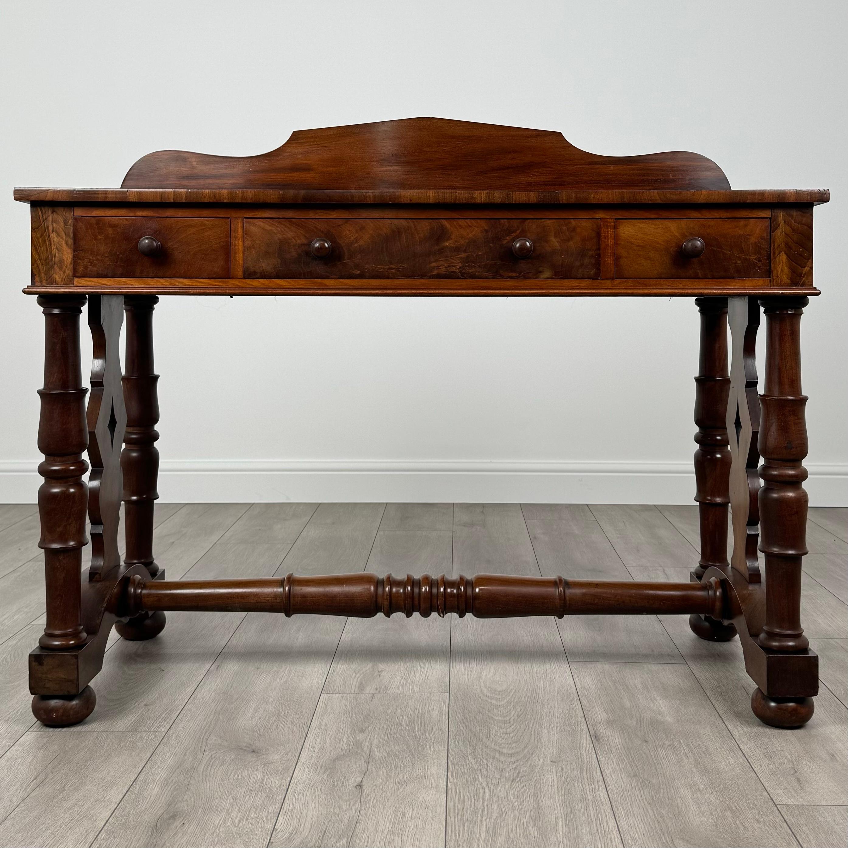 This stunning 19th-century side table, crafted from fine mahogany, is a superb example of antique craftsmanship and design. 
The wood displays magnificent figuring and a rich, warm grain that adds depth and character, making it a standout piece.