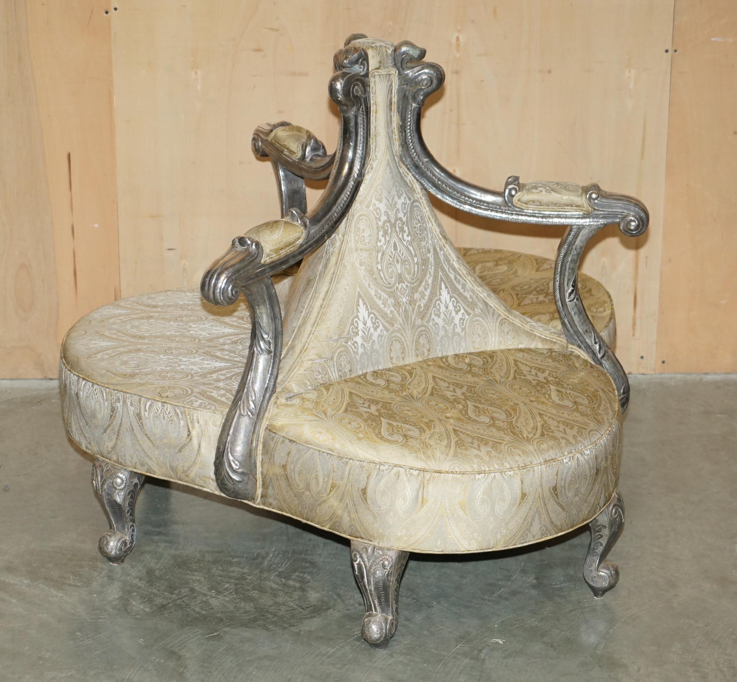 Royal House Antiques

Royal House Antiques is delighted to offer for sale this super rare, highly collectable, ornately hand carved, Antique Italian “Tete a Tete” Conversation couch with silver metal foil wrapped frame in the style of the antique