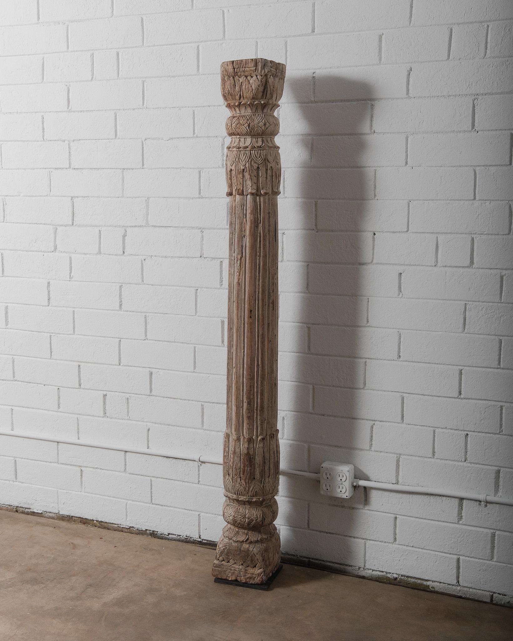 This stunning antique hand-carved wooden architectural column showcases intricate floral and geometric motifs, indicative of traditional Indo-Islamic craftsmanship. Likely originating from the 19th century, this piece reflects Mughal and Indian