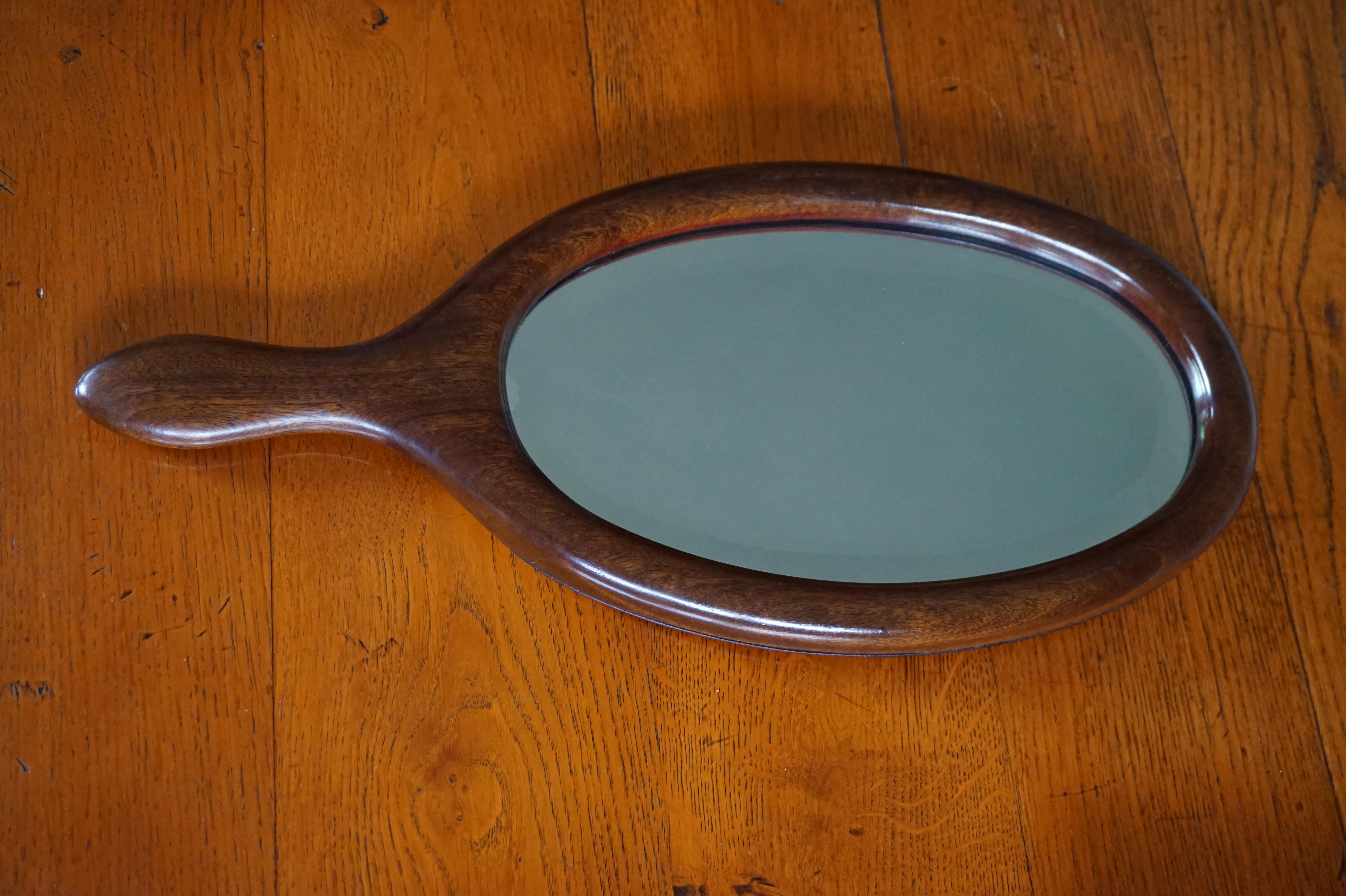 Rare size and great shape antique hand mirror.

This good size and highly practical antique hand mirror can also be used as a wall mirror. The maker of this top quality and all handcrafted antique must have been asked to create a hand mirror in