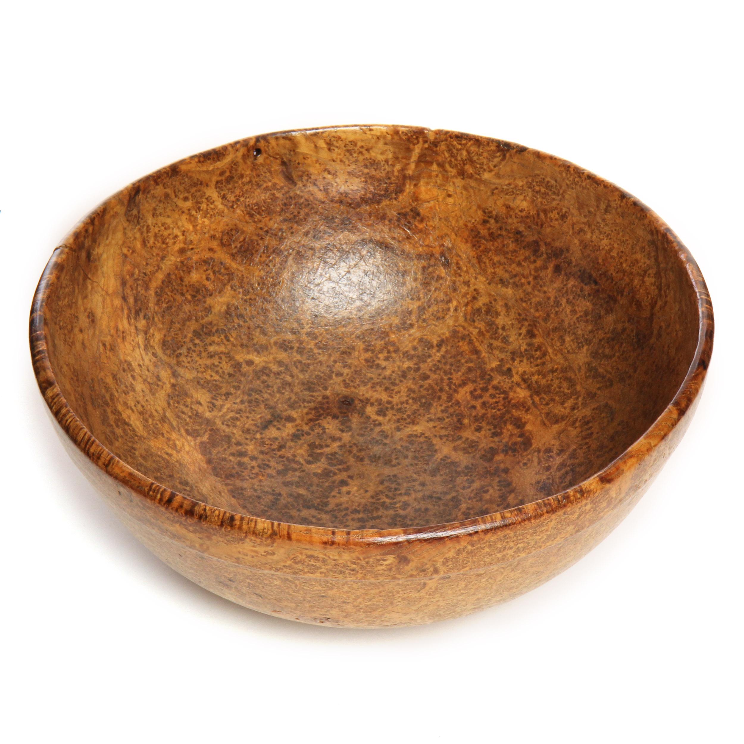 A well scaled bowl carved from a single piece of burled maple.