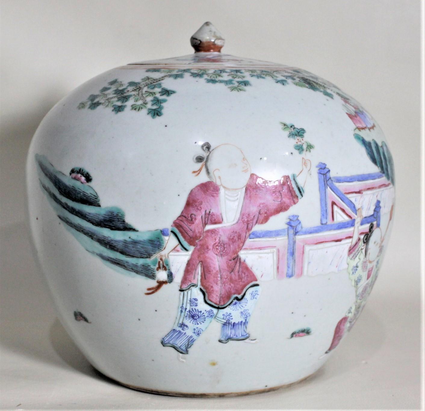 This rather large antique Asian covered jar is unmarked but believed to have been made in China in circa 1880 for the export market. The jar is done with a robin egg blue background with hand painted vignettes around the perimeter with cherry