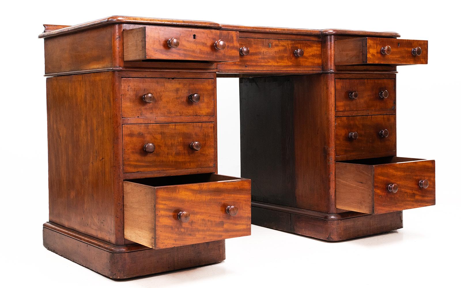 Antique Heals desk

19th Century Victorian pedestal desk by Heal & Son, London, UK.

The desk is in a beautiful rich coloured mahogany, which has aged perfectly. Each pedestal has four drawers with turned handles, and it stands on a moulded