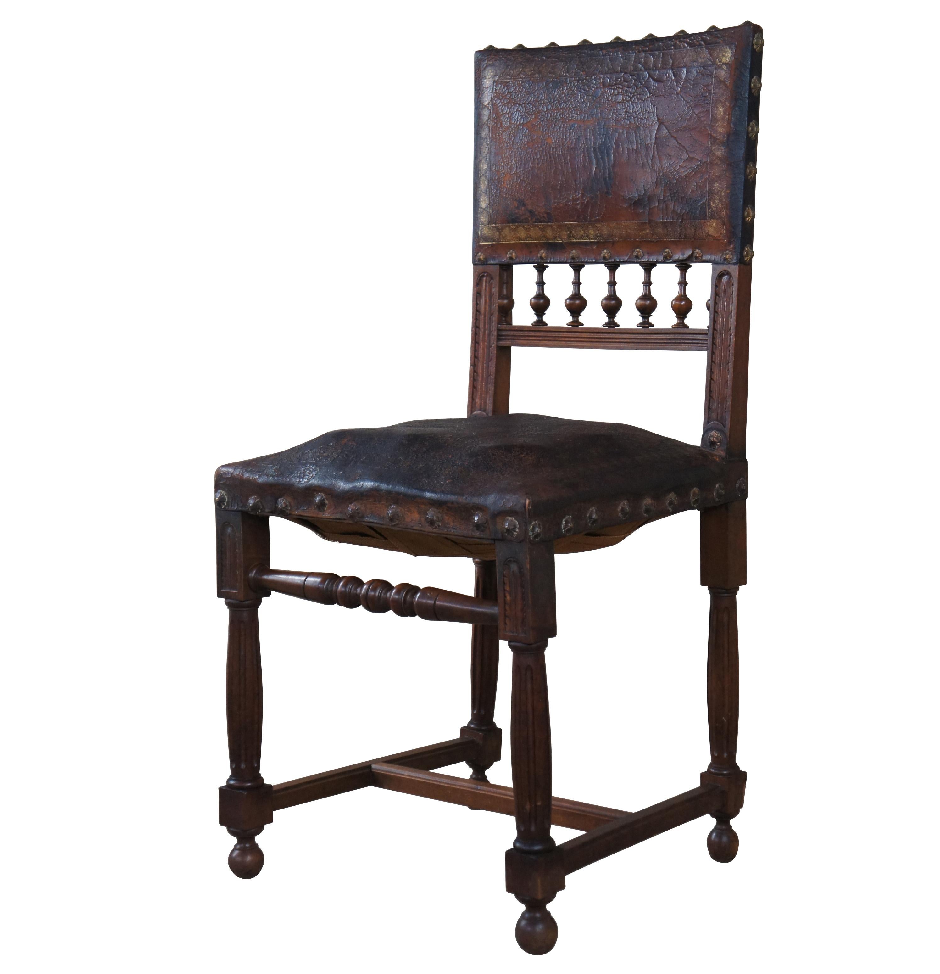 A charismatic 19th century Henry II side or desk chair, circa 1870s. Drawing inspiration from Spanish and Renaissance Revival. Made from mahogany with an aged brown leather having gold tooling. Features baluster turned finials between acanthus