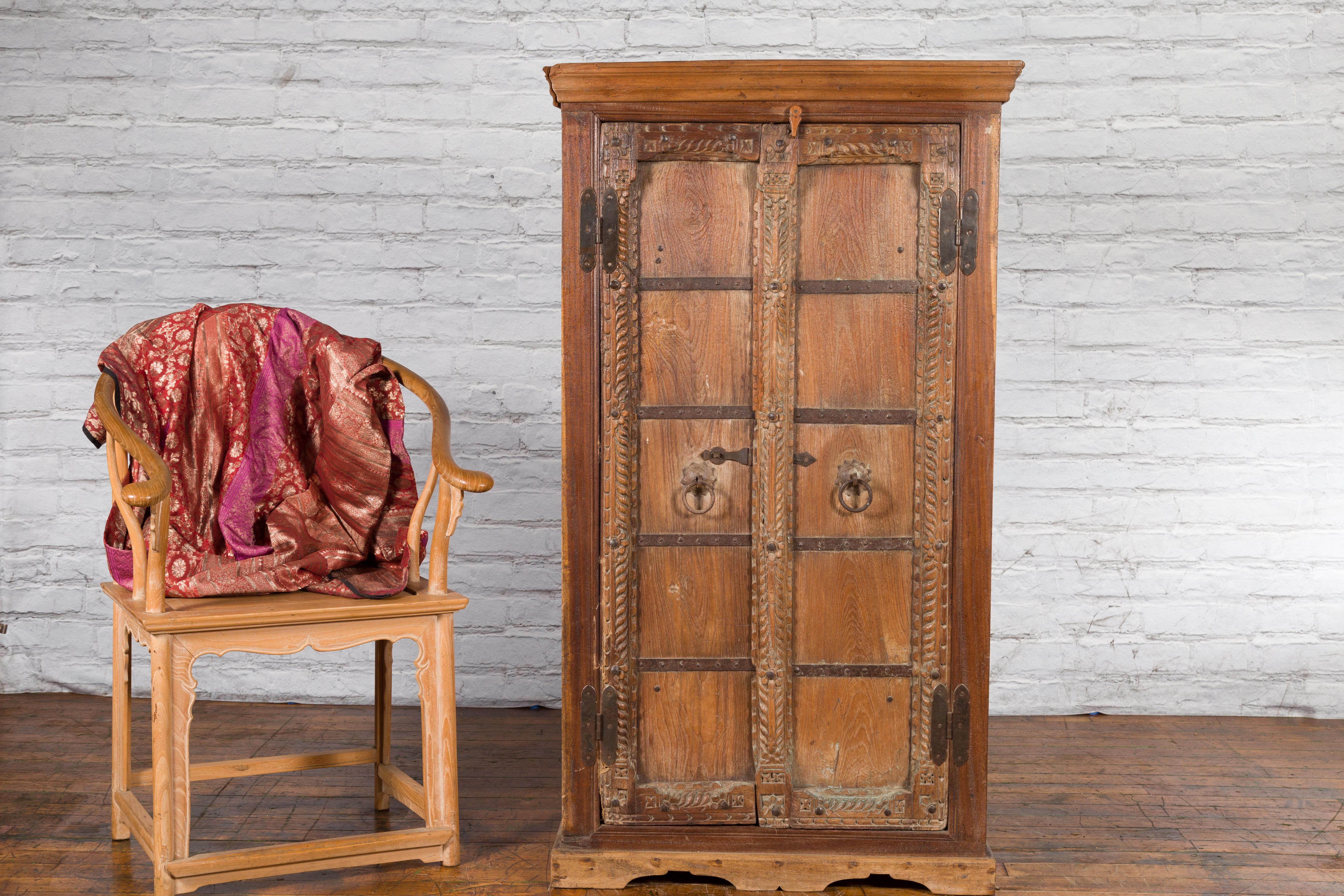Rustic Antique 19th Century Indian Armoire with Metal Braces and Hand-Carved Décor