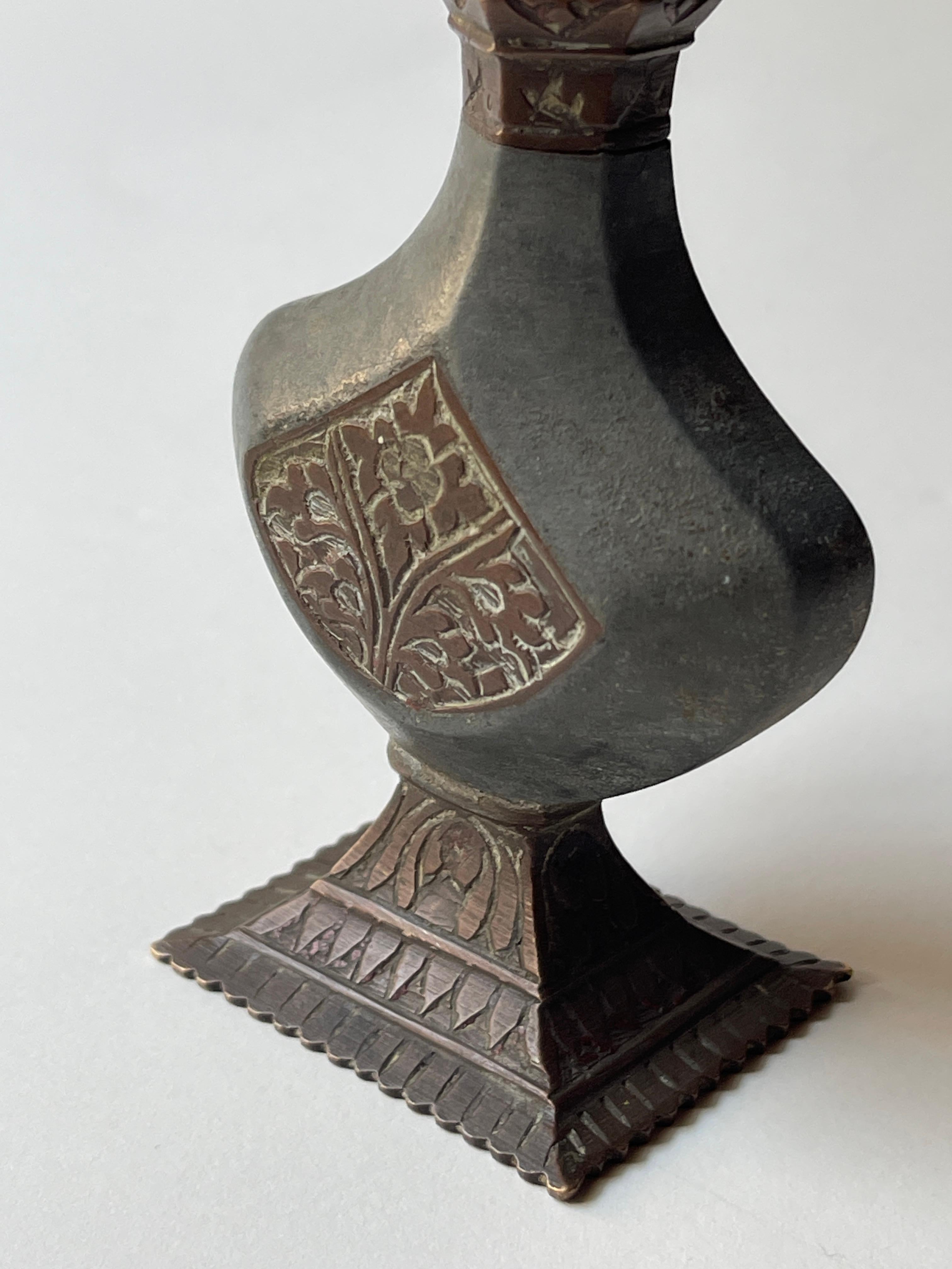 Antique 19th century Indian copper and mixed metal perfume / rose water bottle with original stopper. Copper base and central medallions are finely engraved with Mughal designs.