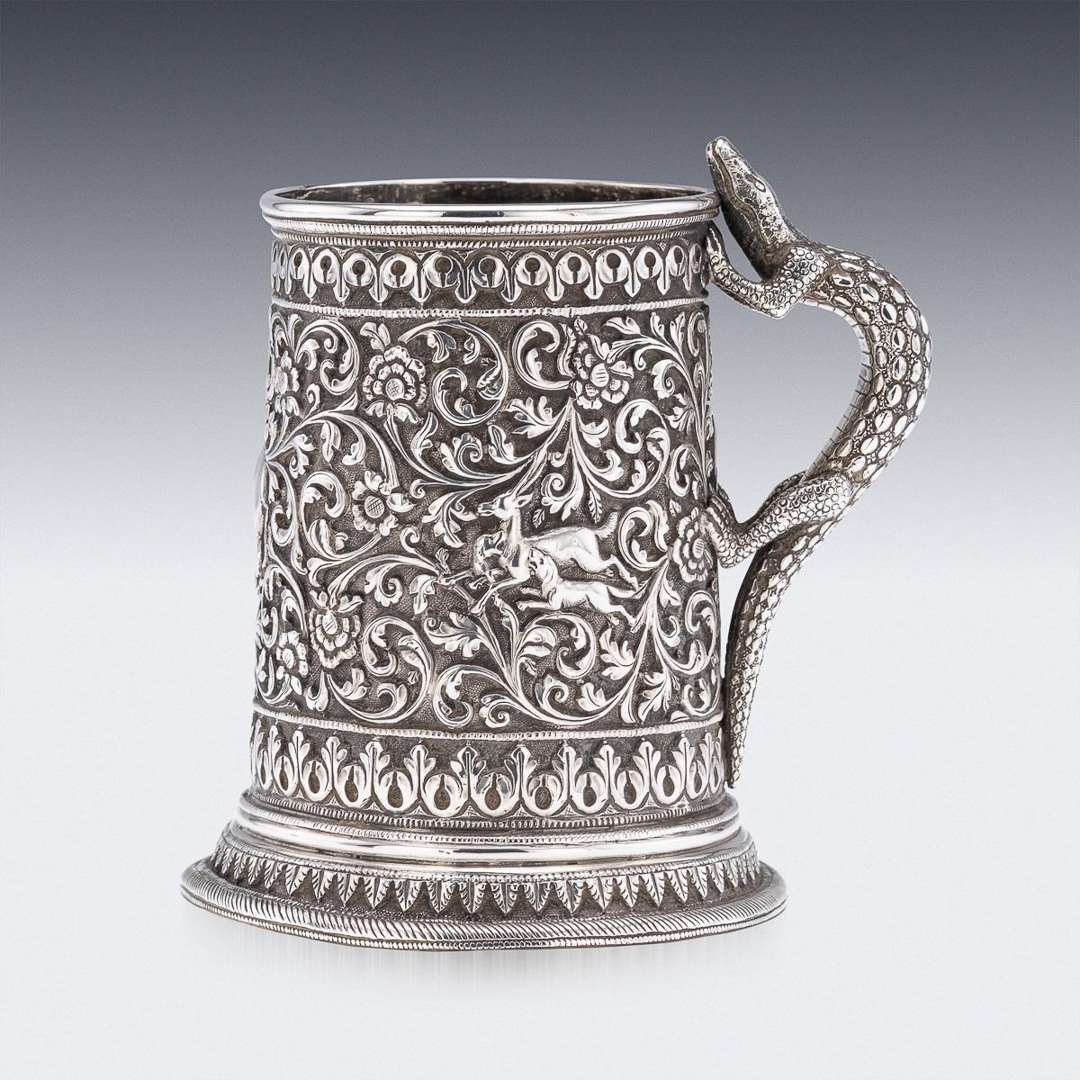 Antique 19th Century Indian Kutch (Cutch) solid silver mug. This exceptionally fine tapered mug is finely decorated throughout with intricate floral repoussé work set against a finely matted background, showcasing the remarkable skill and attention