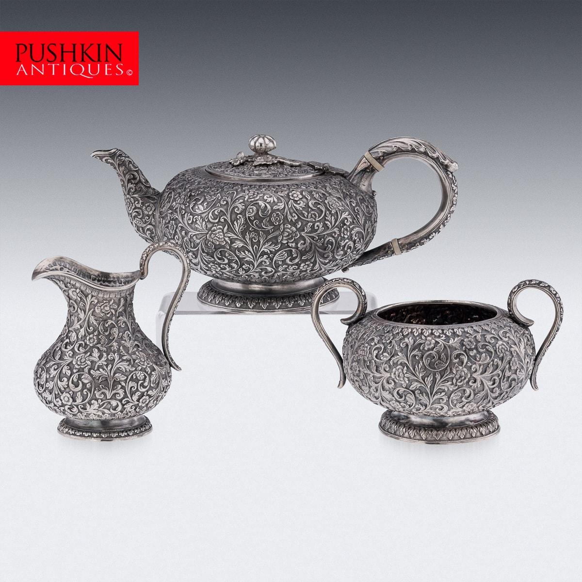 Antique late-19th Century Indian (Kutch) solid silver three-piece tea set, comprising of a teapot, sugar bowl, cream jug and tray, each piece is profusely and beautifully repousse' decorated with scrolling foliage and flowers on a tooled ground,