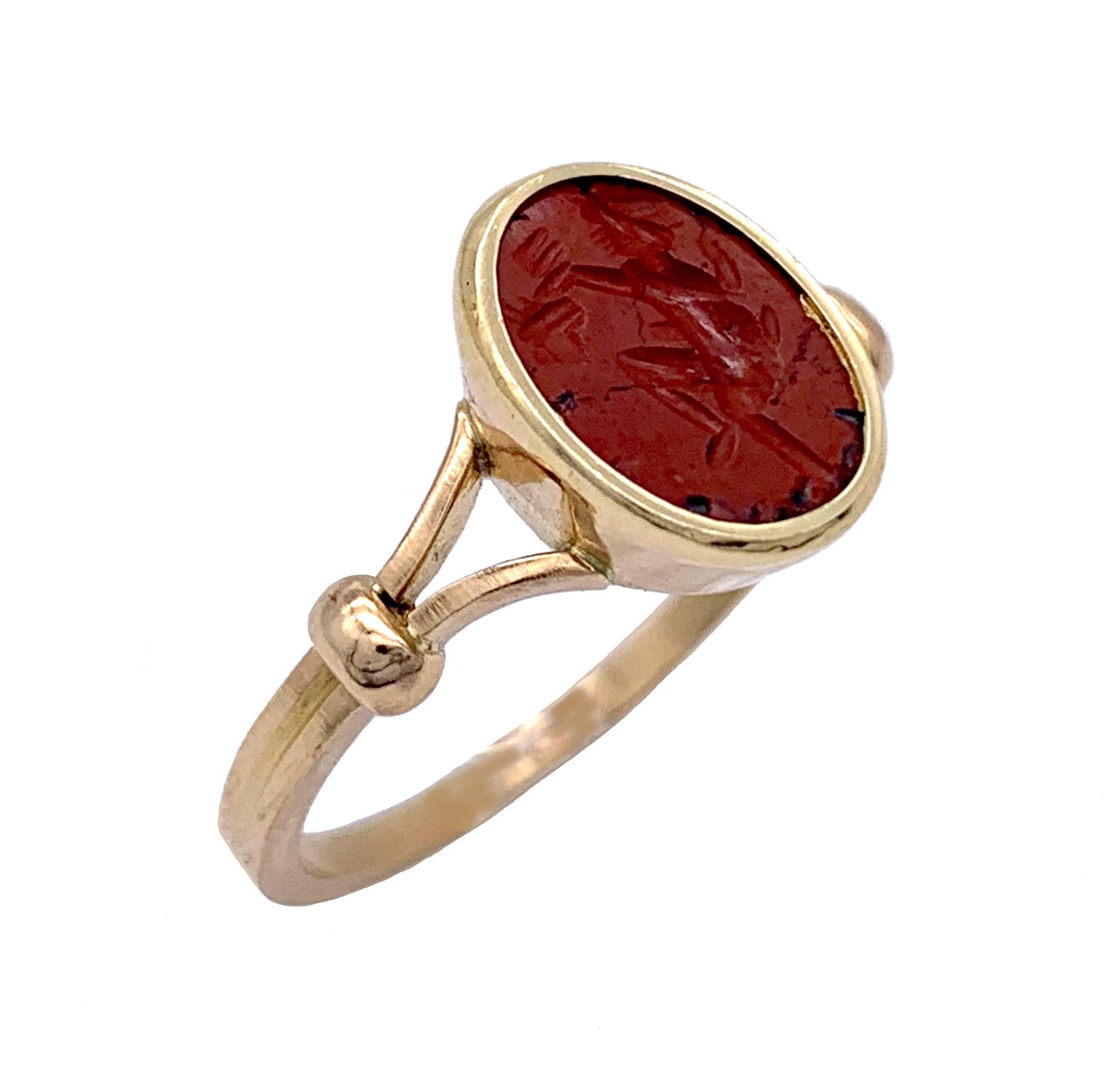 The  oval red jasper intaglio dates fom of the nineteenth century, possibly earlier. A male figure, probably a warrior, is making a sacrifice. The stone is mounted in an attractive delicate contemporary 18 karat gold ring.

Size of the framed