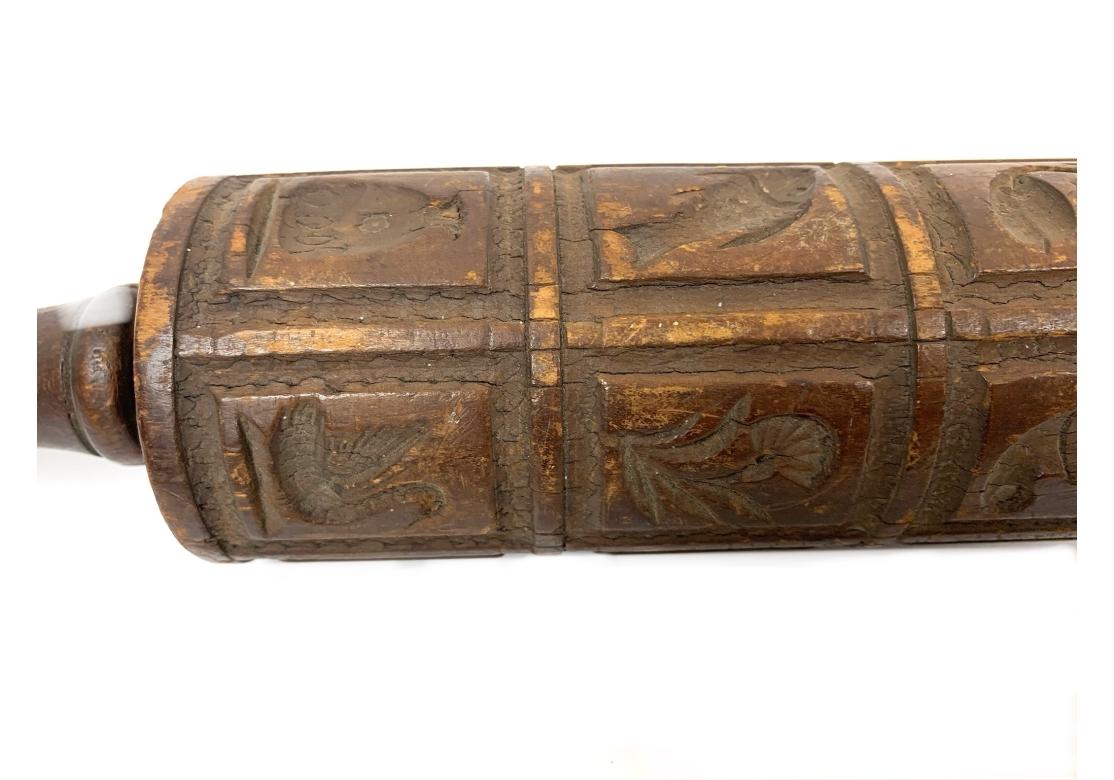 Springerle rolling pin, a specialized baking tool used to imprint decorative designs onto dough, particularly for making traditional Springerle cookies. Features various designs, from traditional motifs like animals, flowers, and religious symbols