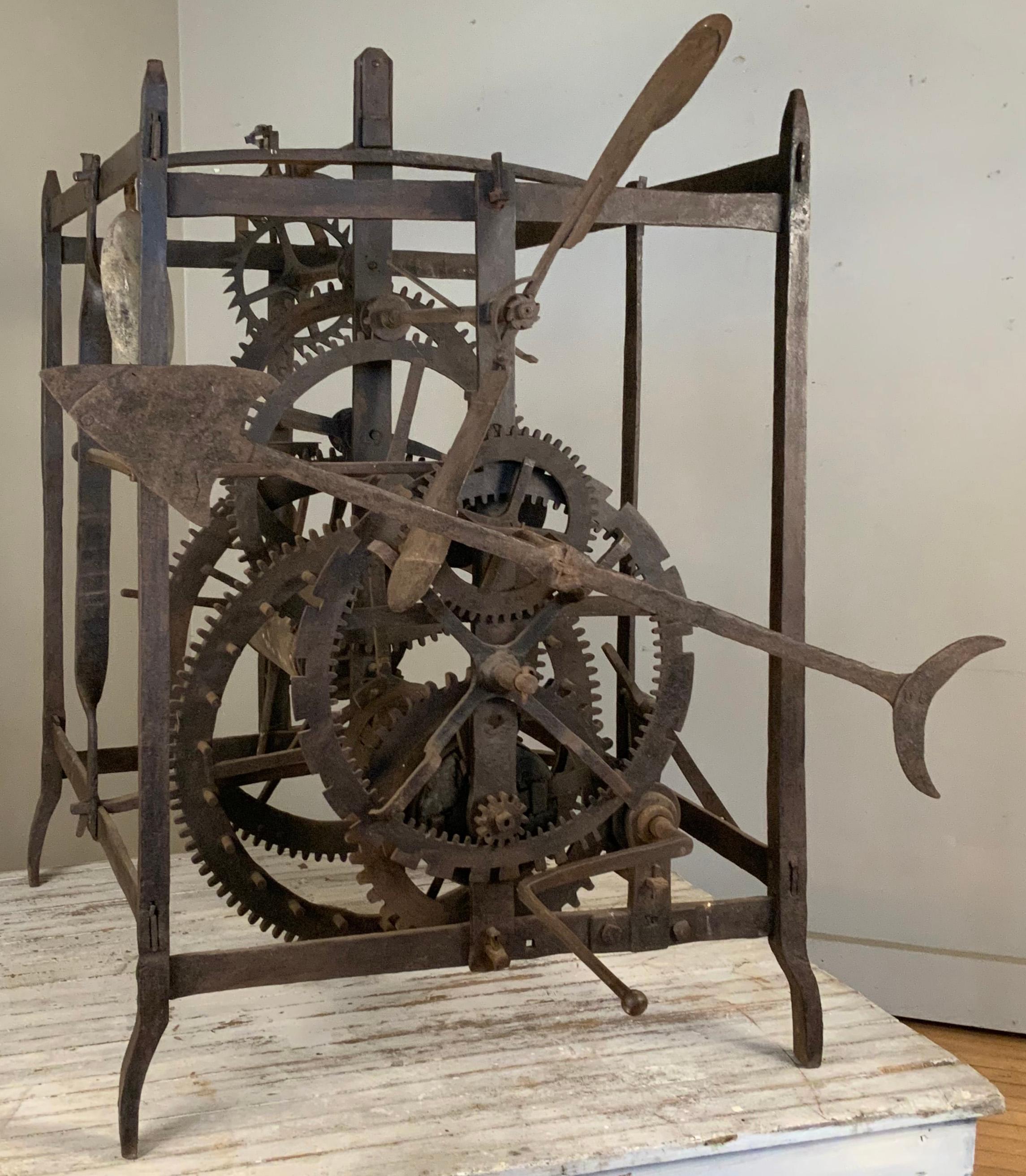 An incredible early 19th century Italian bell tower Clockworks, with all of its original wrought iron gears and pulleys, in the original iron frame. wonderful piece of sculptural history, it retains the original polished stone weight, the forged