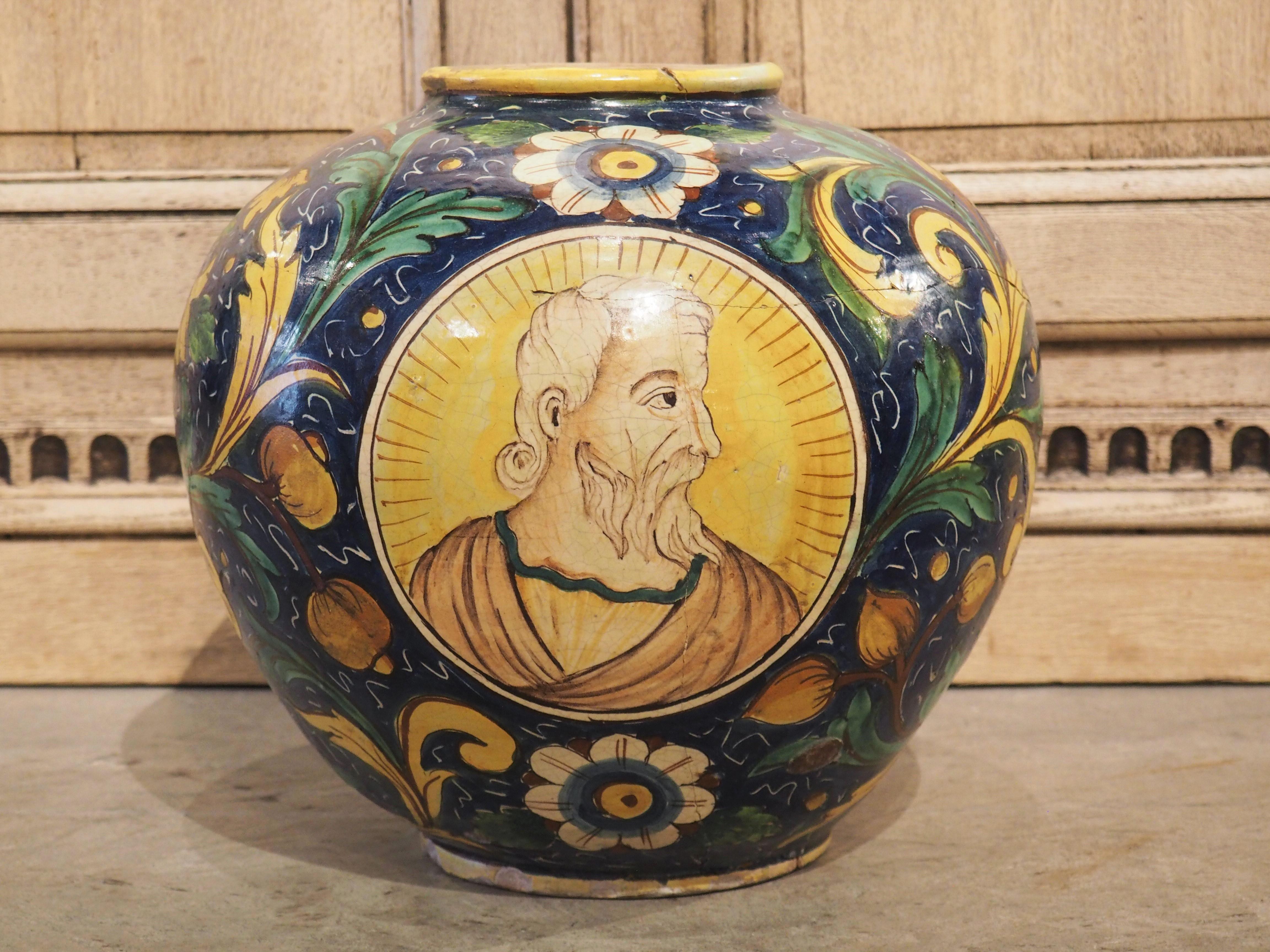 Vivid colors, hand-painted in the Renaissance style, enhance this large maiolica pot from the 1800’s. Maiolica is tin-glazed pottery from Italy that has been decorated over a white background. This pot is considered an istoriato, which is to say