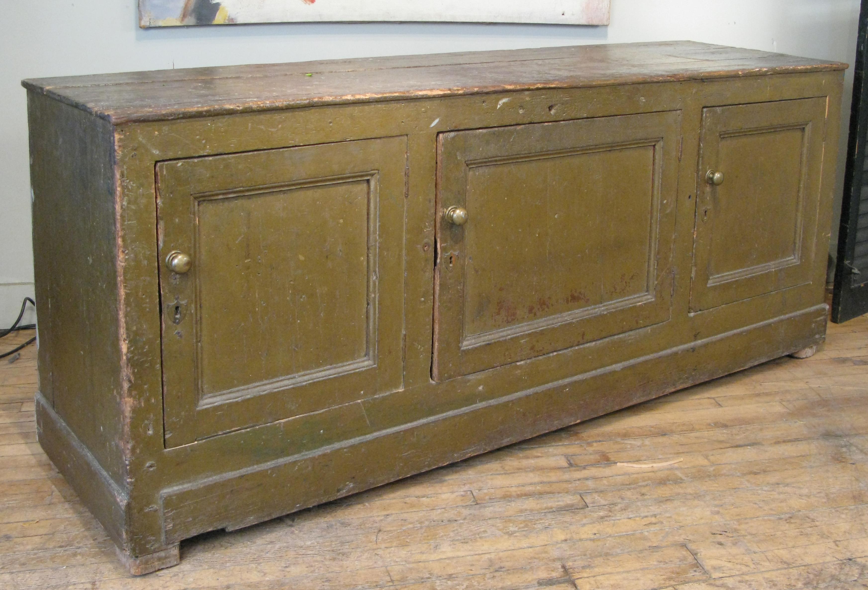 A beautiful late 19th century large three door Italian mercantile cabinet, in its original dark green painted finish and brass hardware. wonderful scale and character.